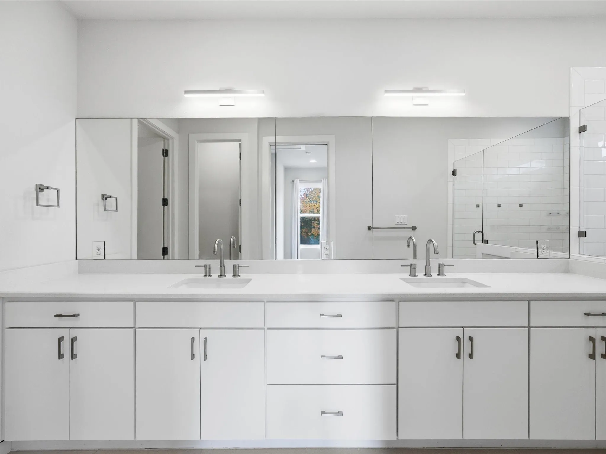 Bathroom with double vanity and a shower stall