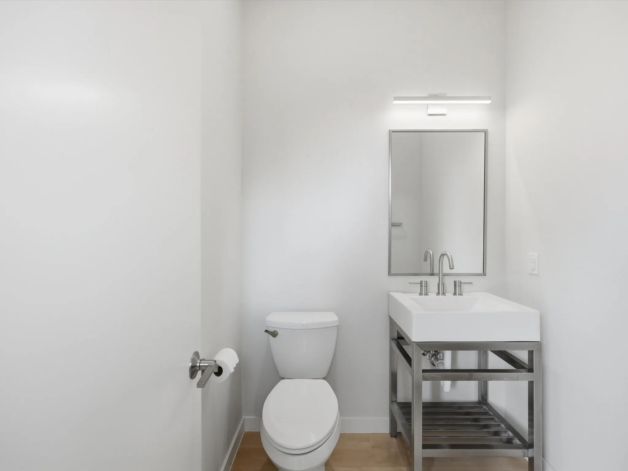 Bathroom with toilet and light wood-type flooring