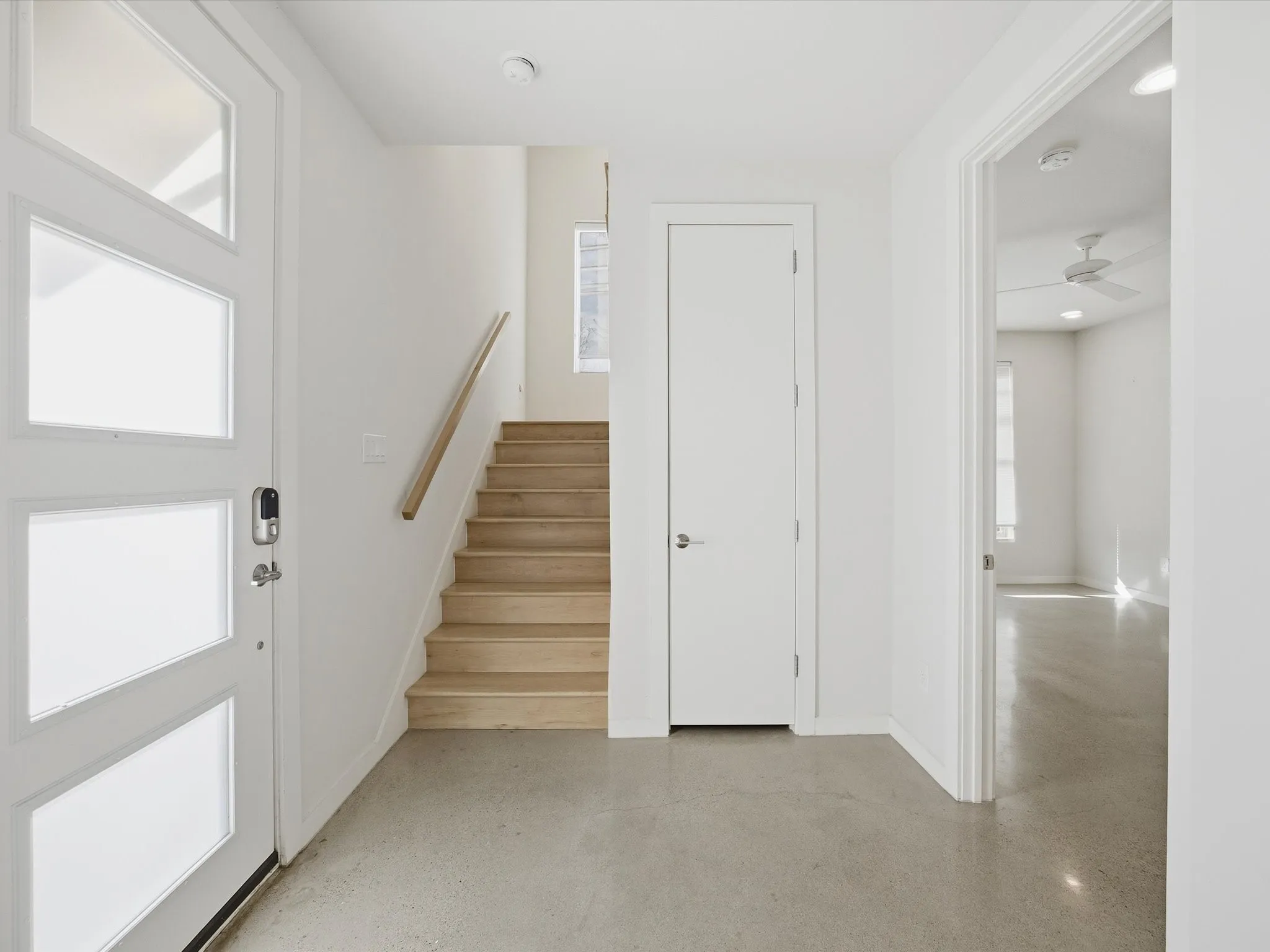 Foyer featuring stairs and a ceiling fan