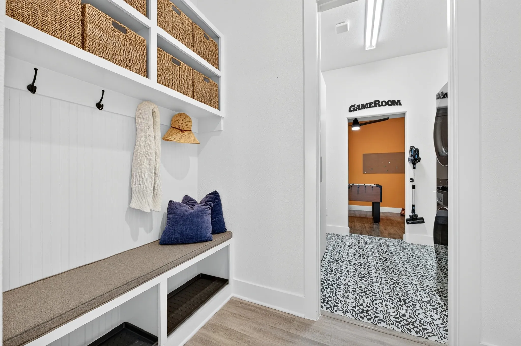 Built-in bench seating with storage, integrated shelving, and wall-mounted hooks
