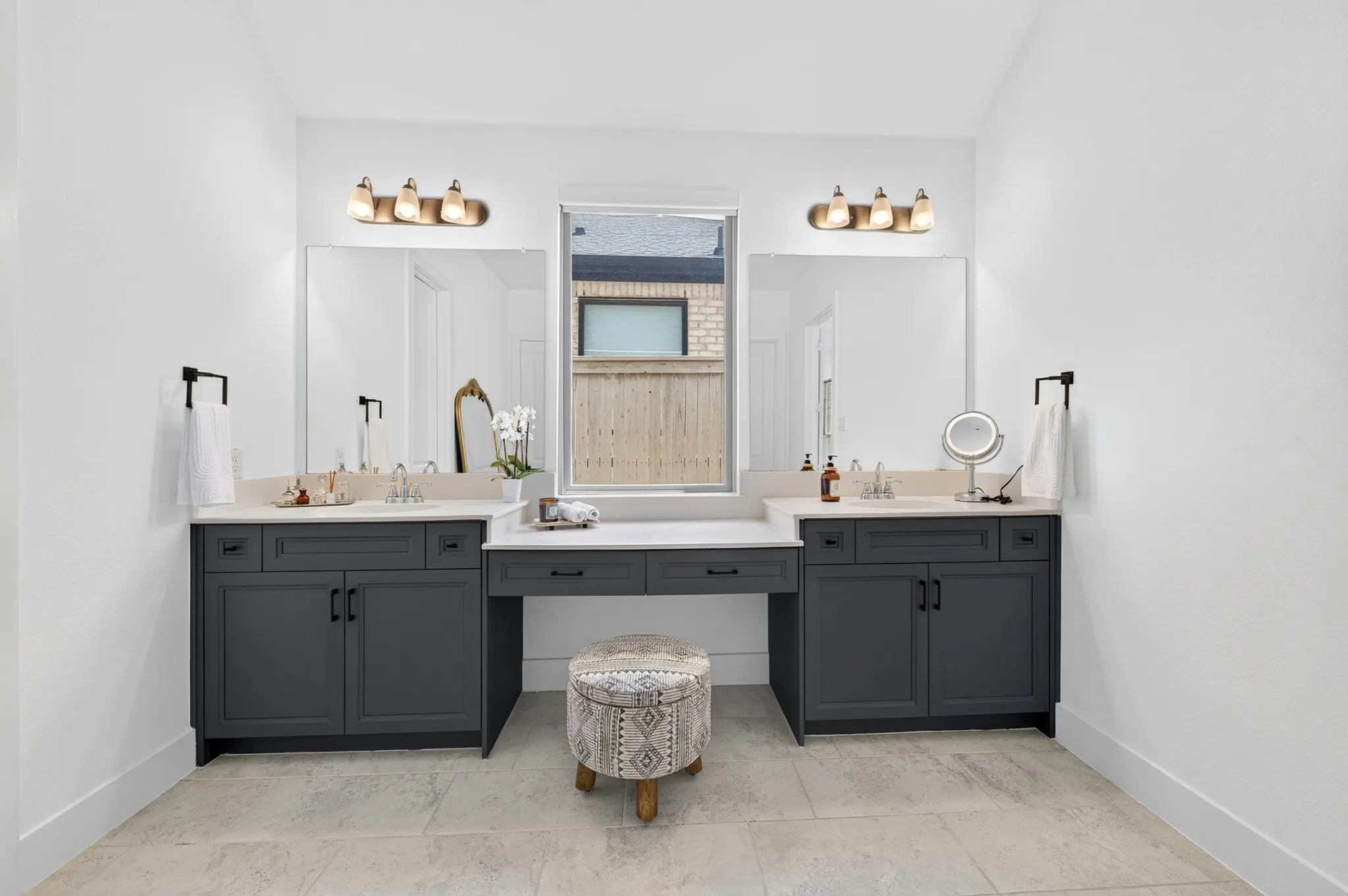 Dual vanity with gray cabinetry, white countertops, and integrated sinks