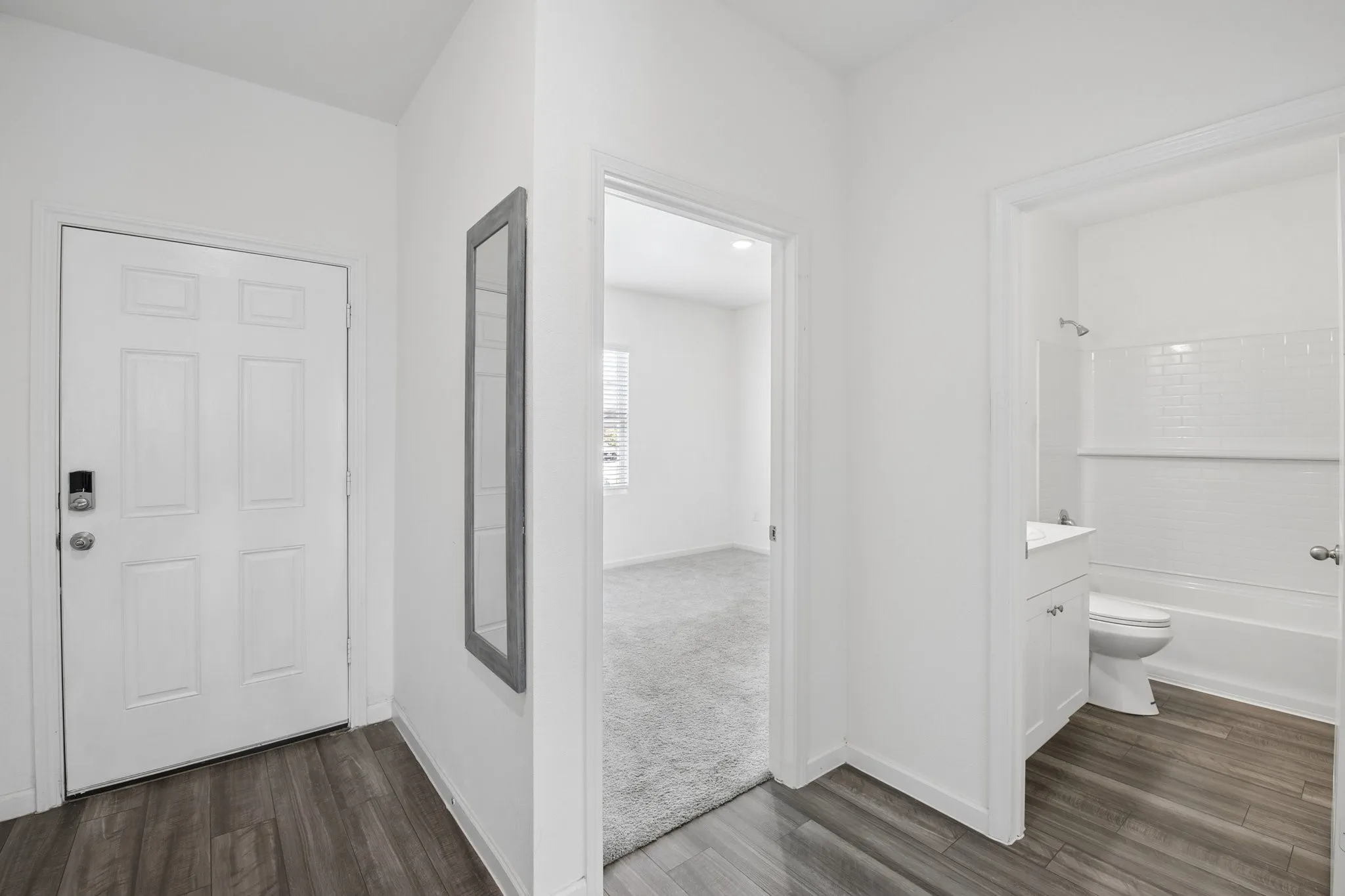 Entry foyer opens to the hallway and 2 bedrooms, guest bath