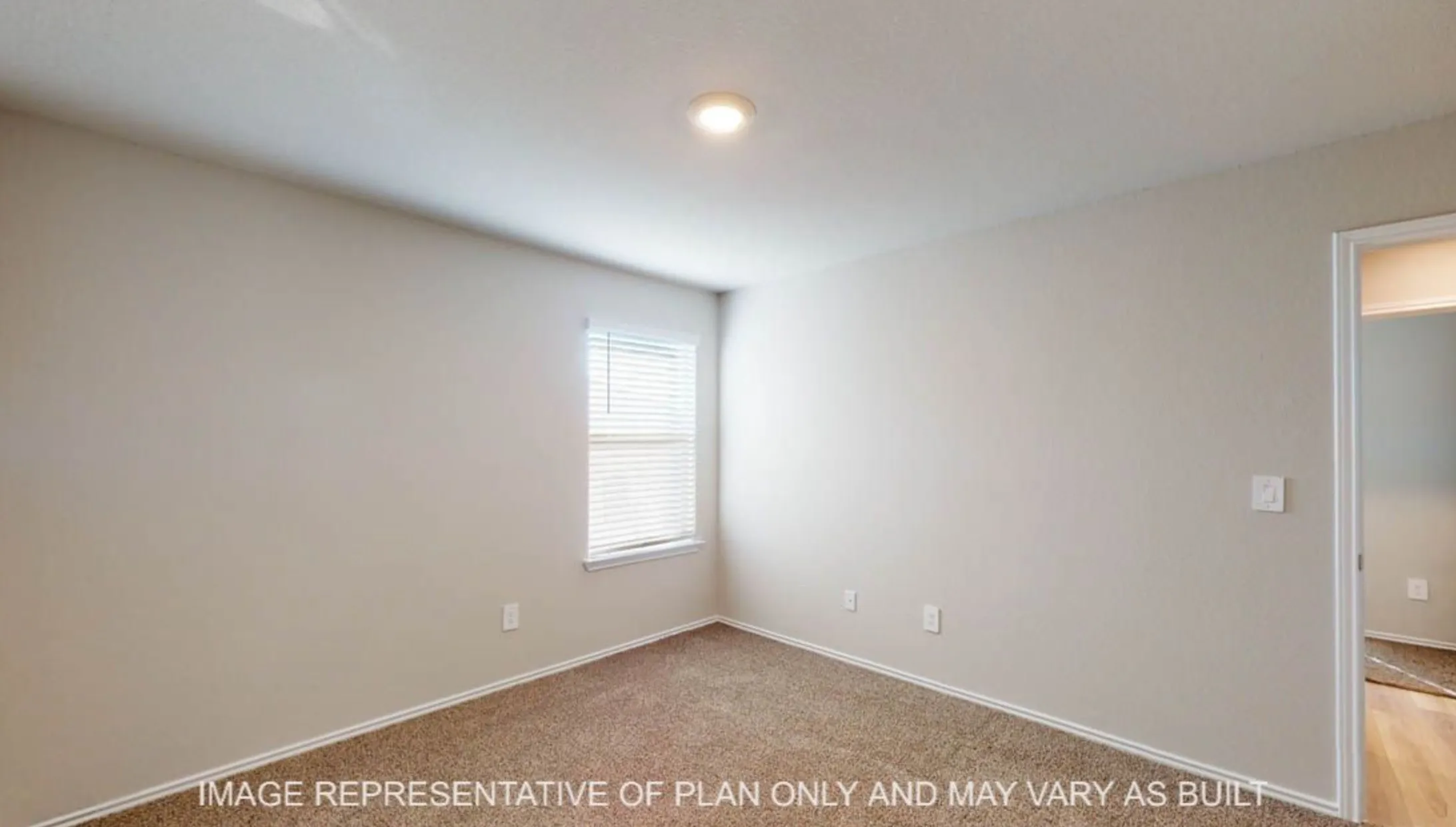 Recessed ceiling lighting, neutral-toned walls, and carpet flooring