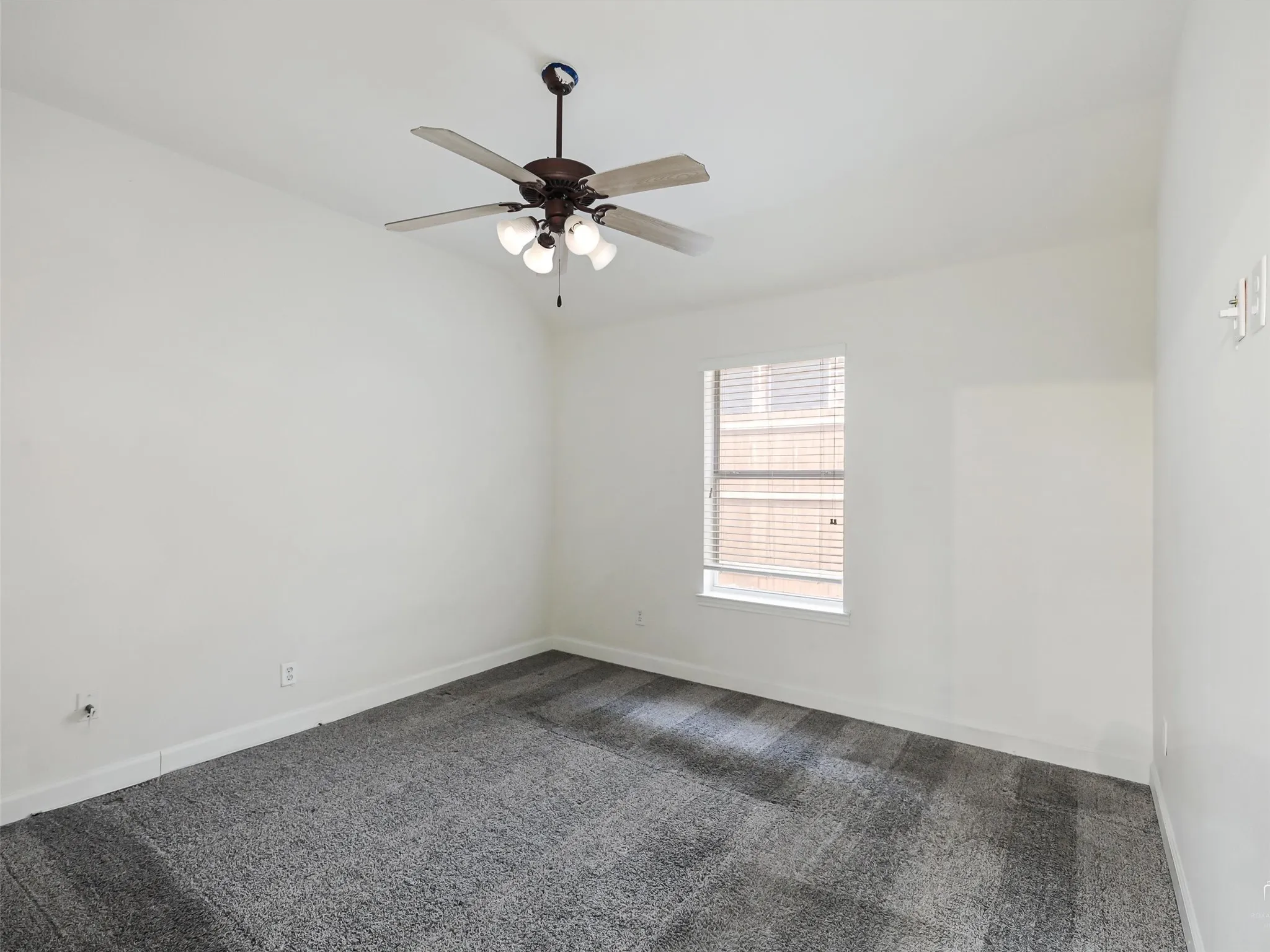 White walls with a textured gray carpet