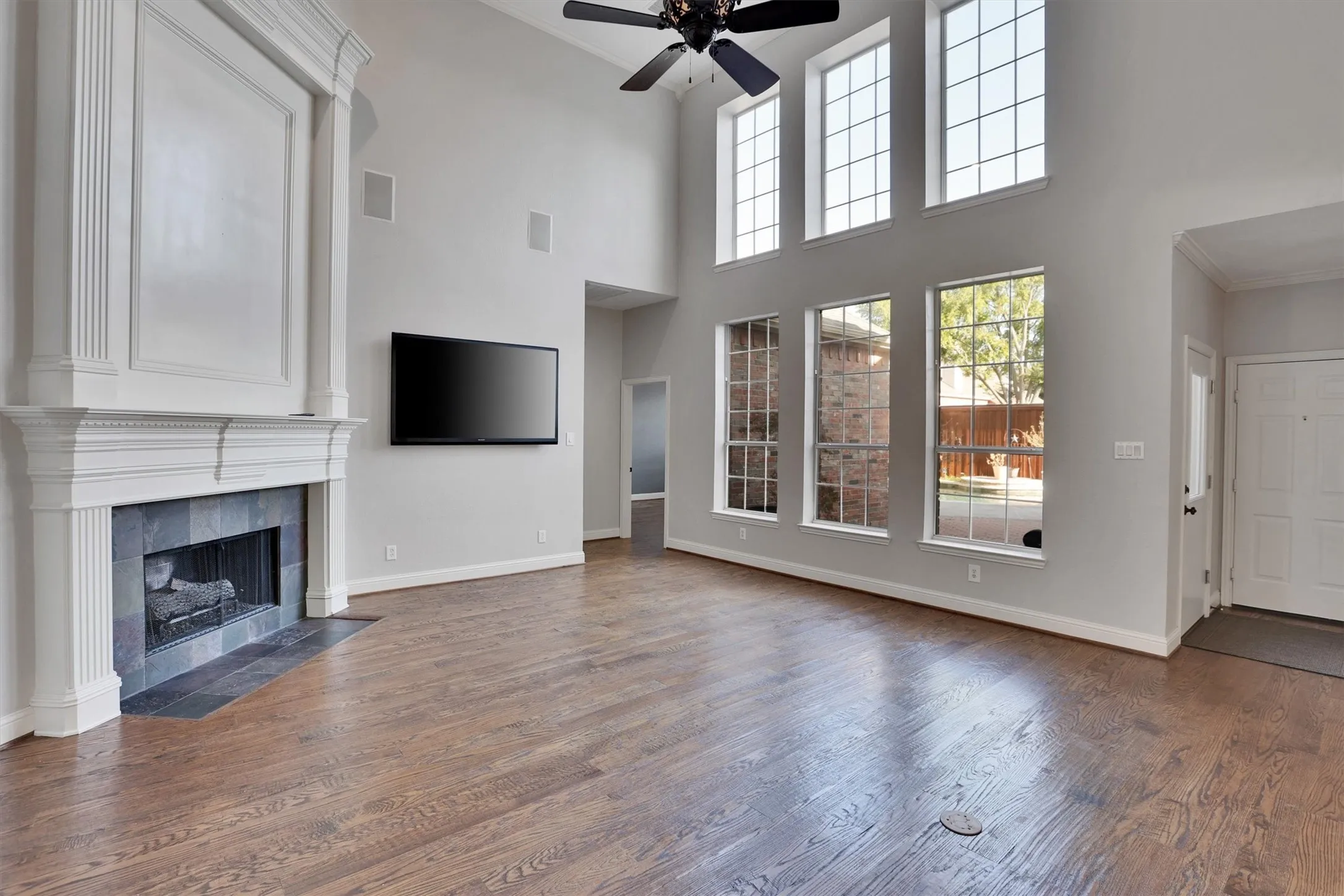 Light and bright with tall ceilings, fireplace, and a view of the beautiful backyard pool