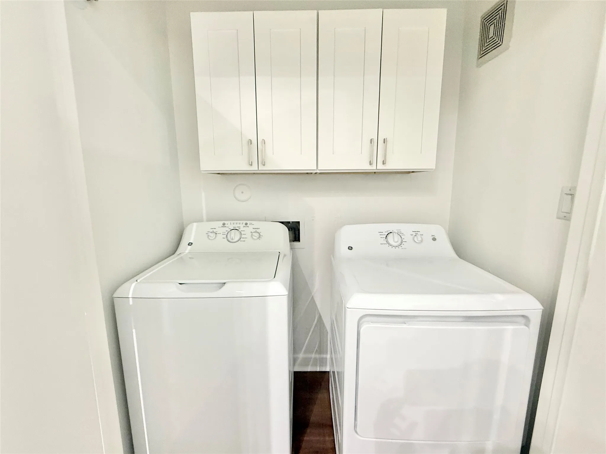 Washroom with separate washer and dryer and cabinet space