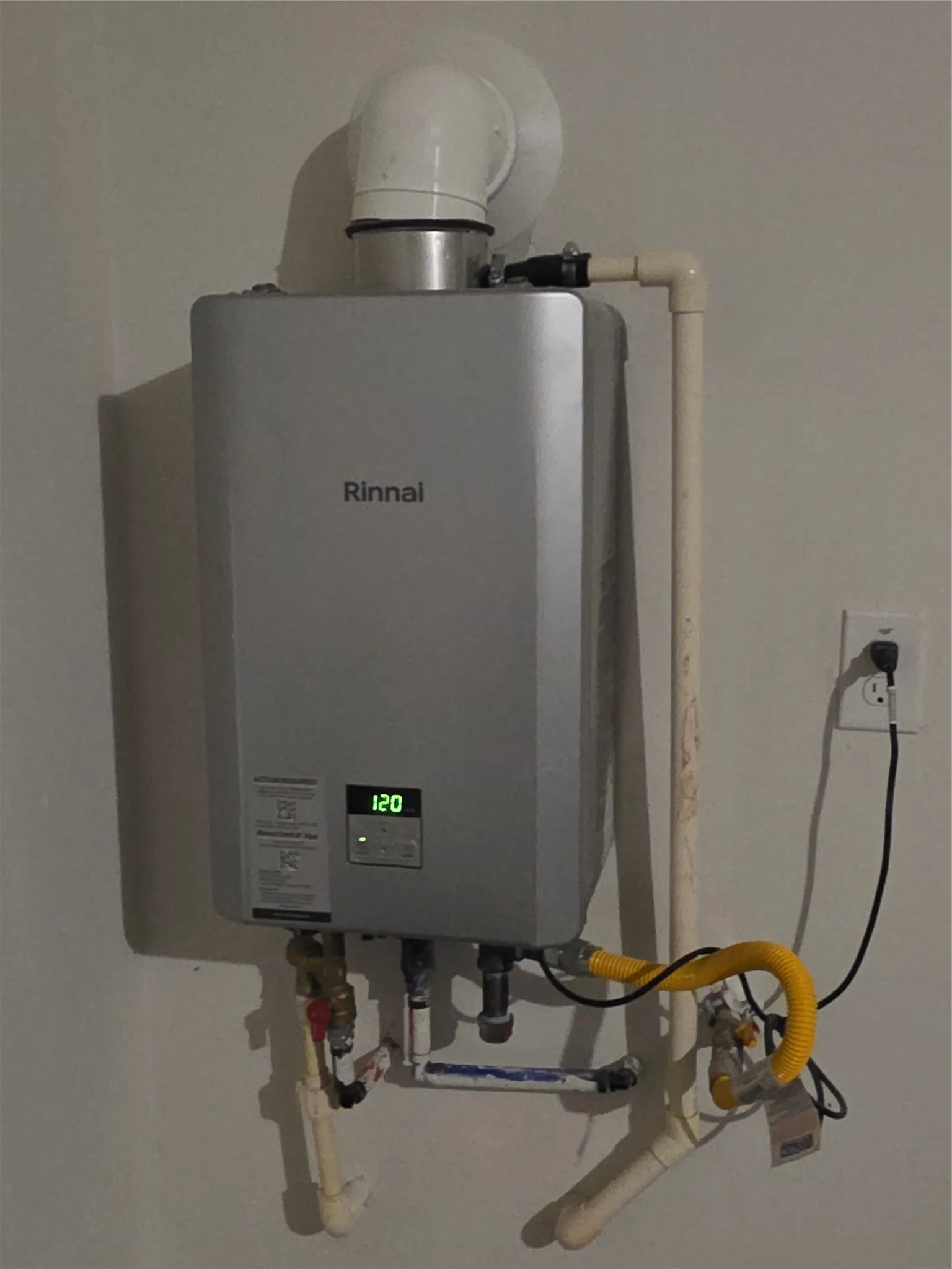 Wall-mounted tankless water heater with visible temperature display