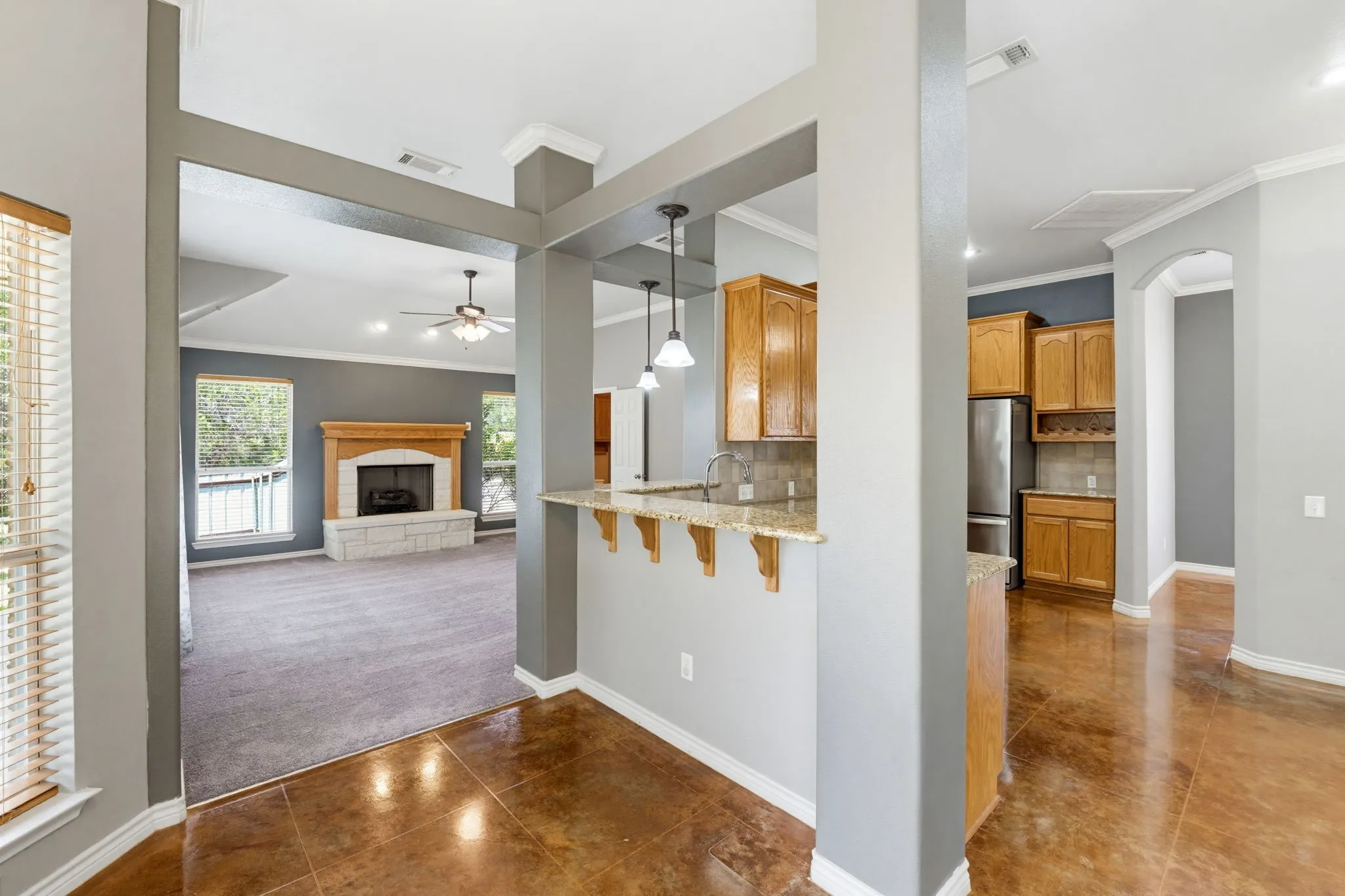 Kitchen with wood cabinetry, granite-finish countertops, and stainless steel appliances