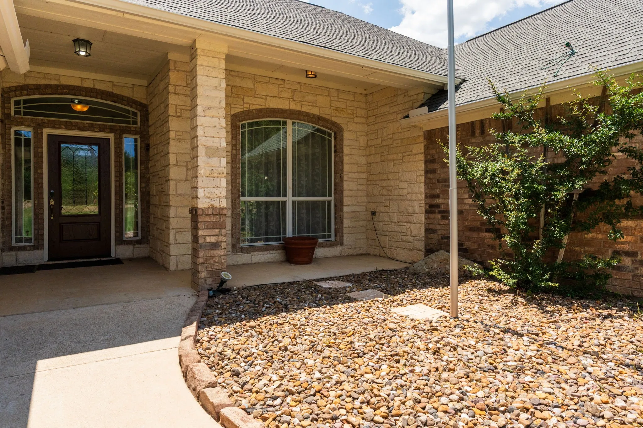 Stone and brick exterior with a covered porch