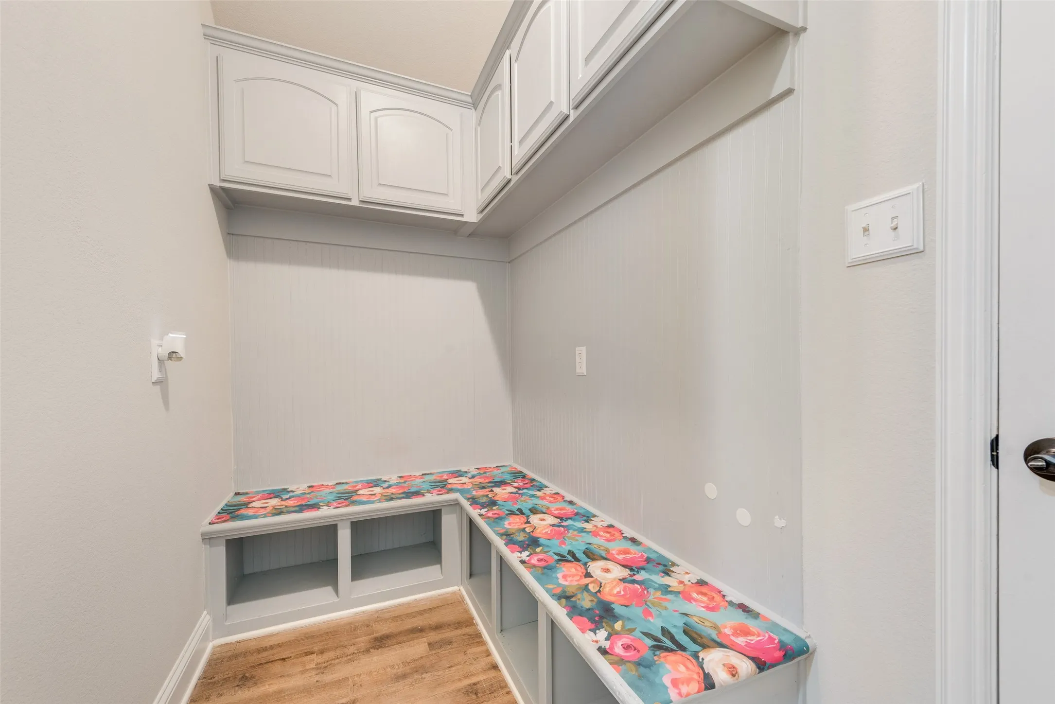 Virtually staged. Vaulted ceiling with a ceiling fan, wood-finish flooring, and multiple windows with blinds