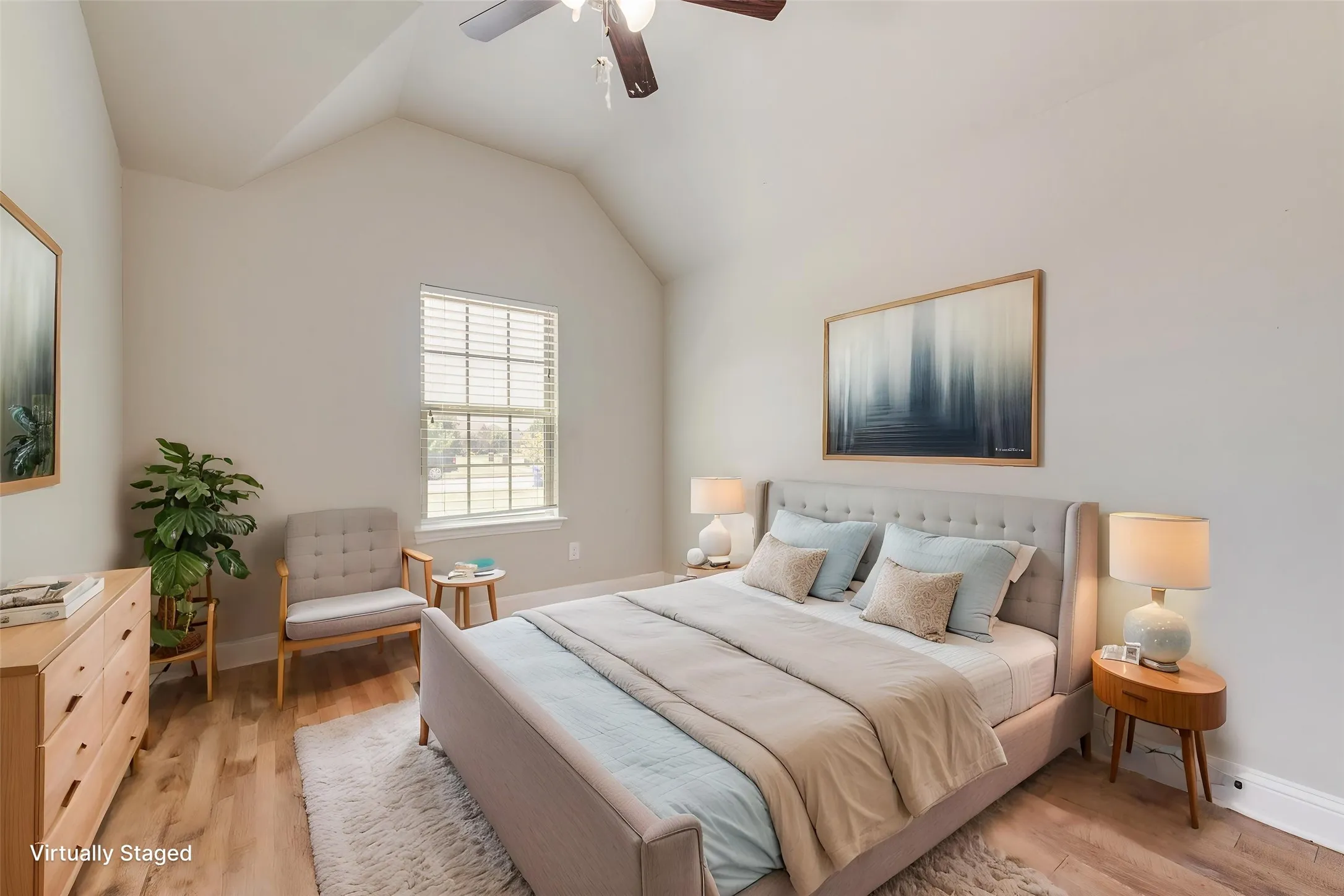 Virtually staged. Vaulted ceiling with a ceiling fan, window with horizontal blinds, and wood-finish flooring