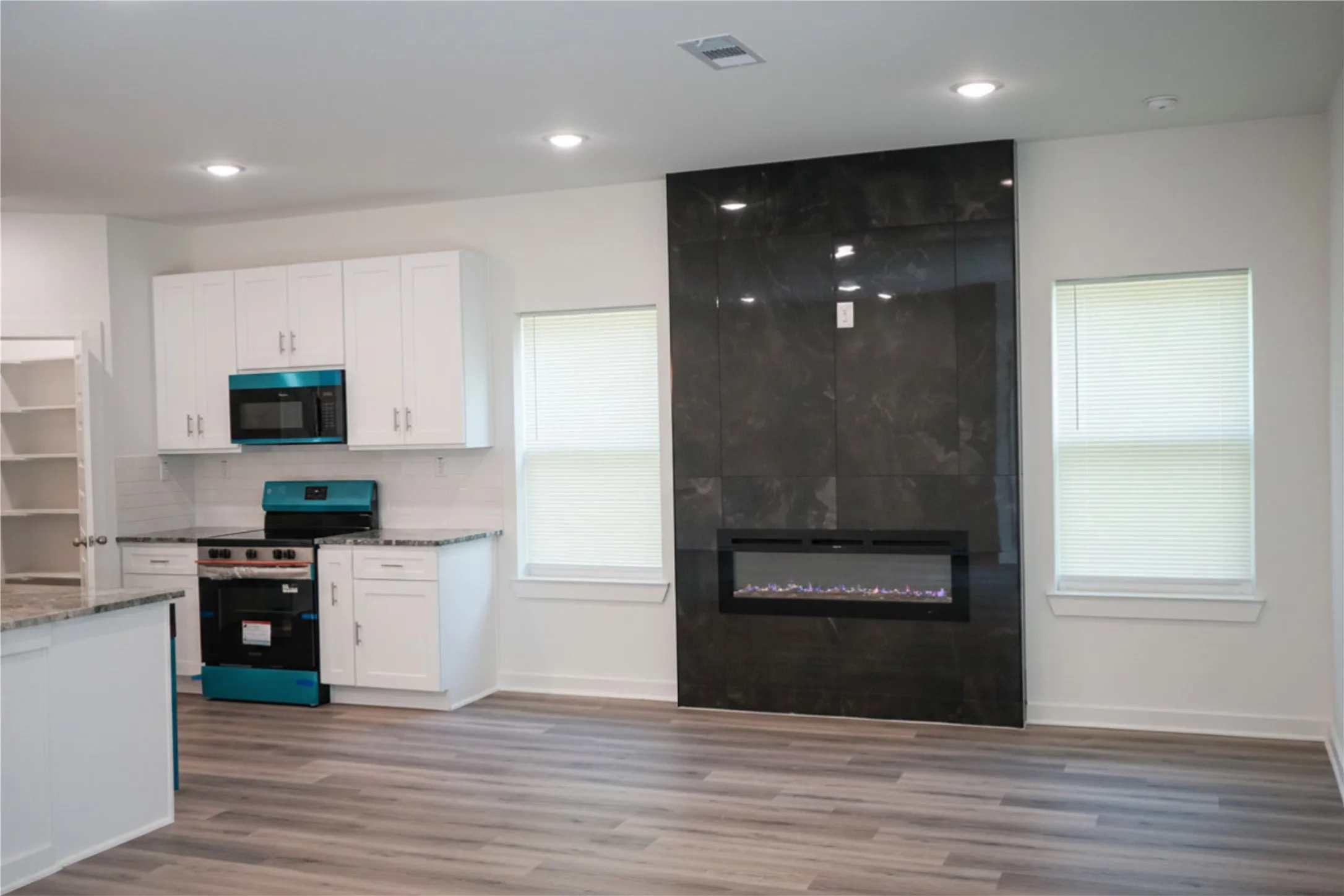 Open concept living area with wood-finish flooring