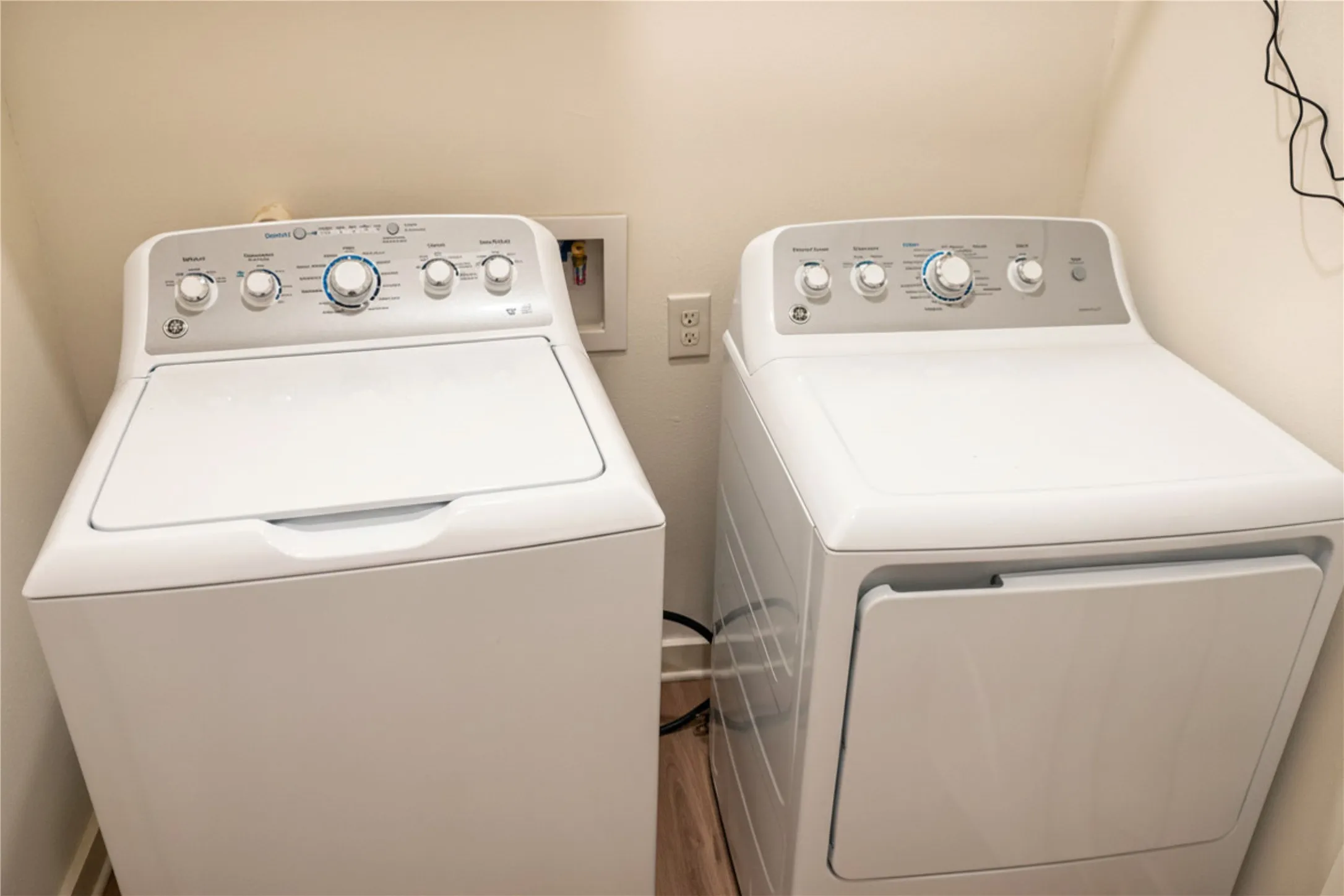 White top-load washing machine and white front-load dryer