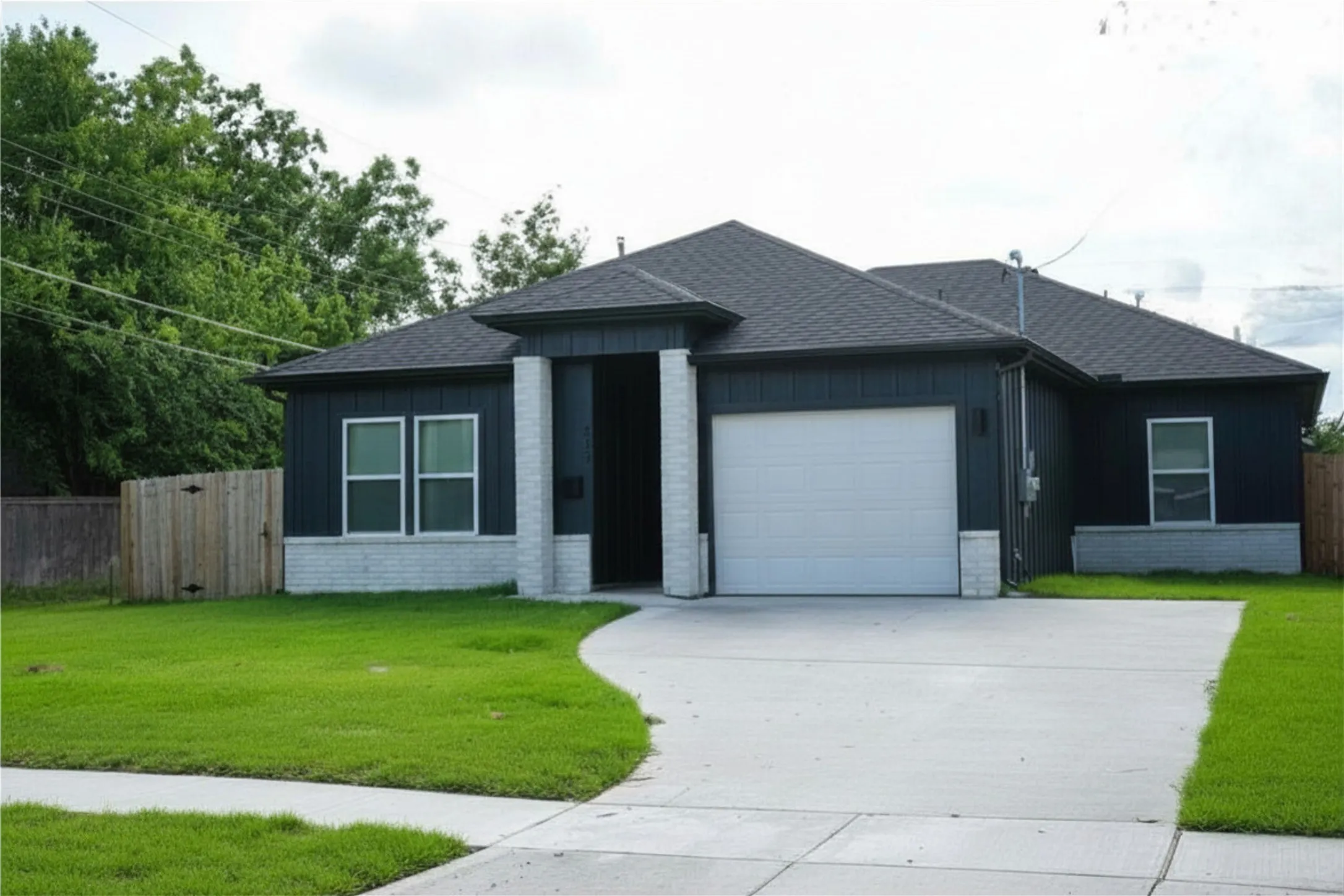 Modern exterior with dark vertical siding and white brick accents