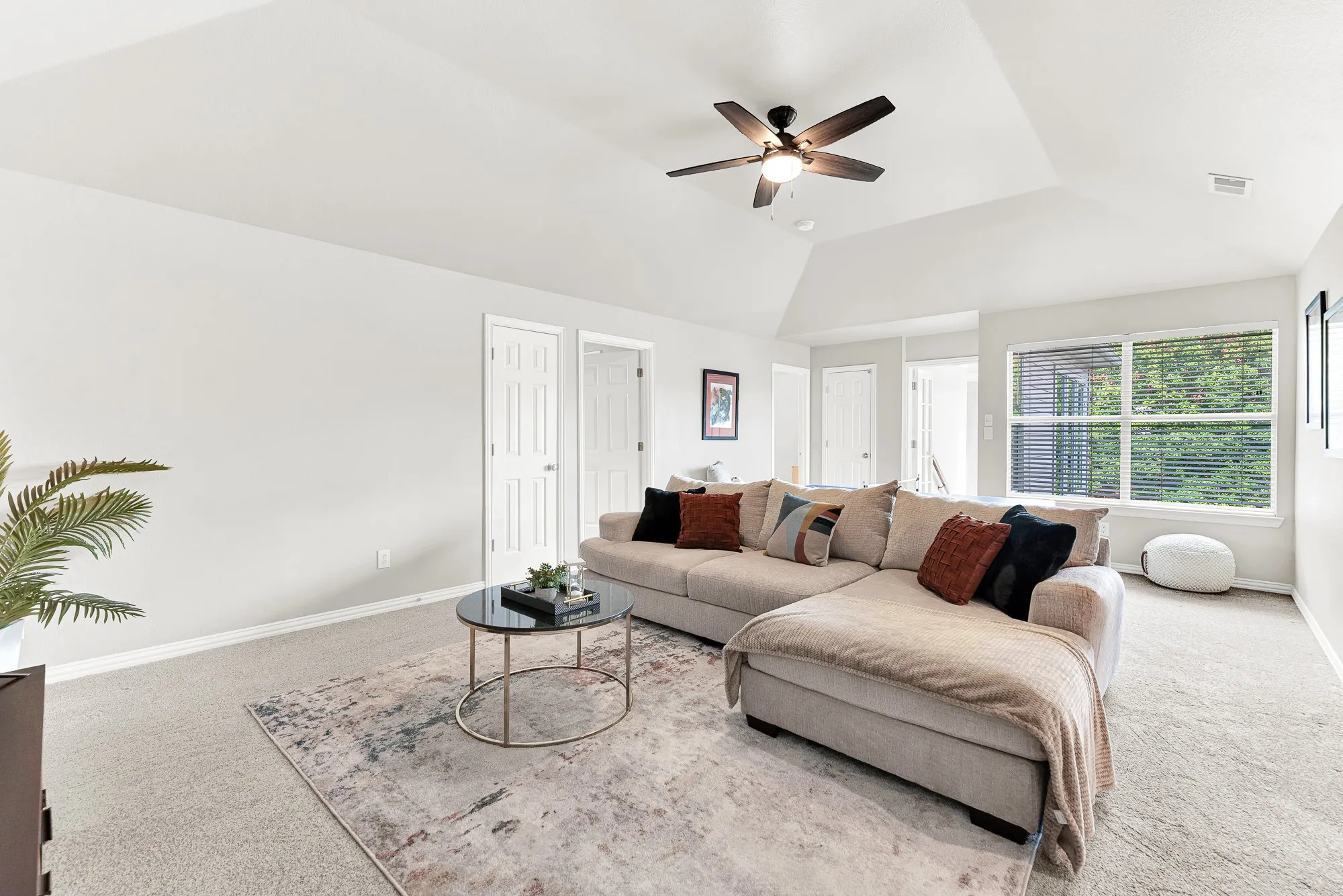 A wide double window filters soft natural daylight across smooth neutral walls and open floor space. You can host energetic family ping-pong tournaments before settling in for a cozy Friday evening together.