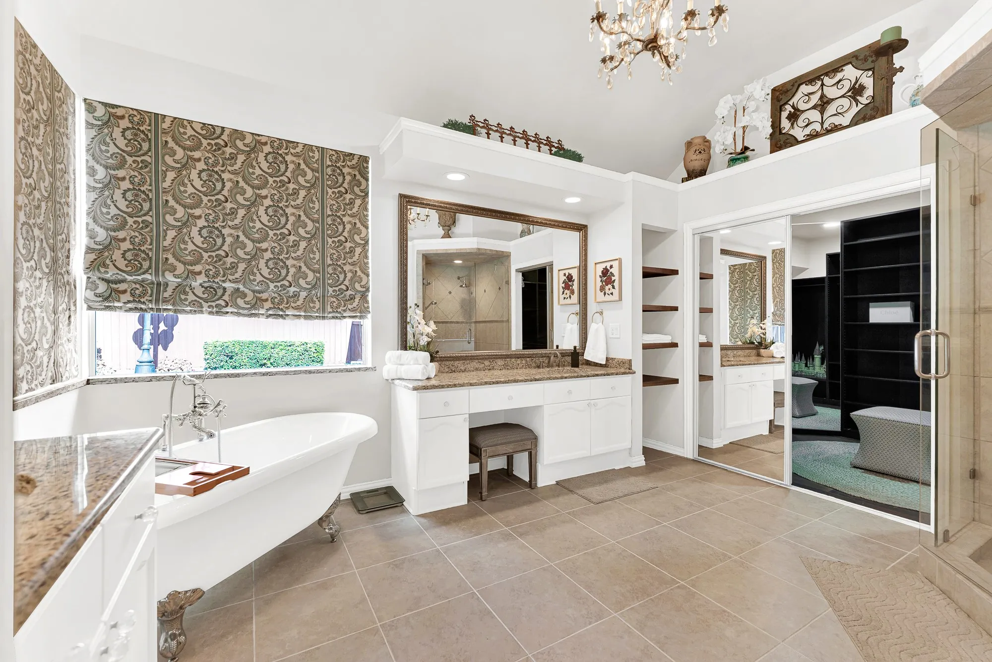 A classic freestanding clawfoot tub sits nestled beside framed garden windows below high, angled ceilings. Soak away a long workday in a warm, relaxing bath surrounded by serene, spa-like privacy.