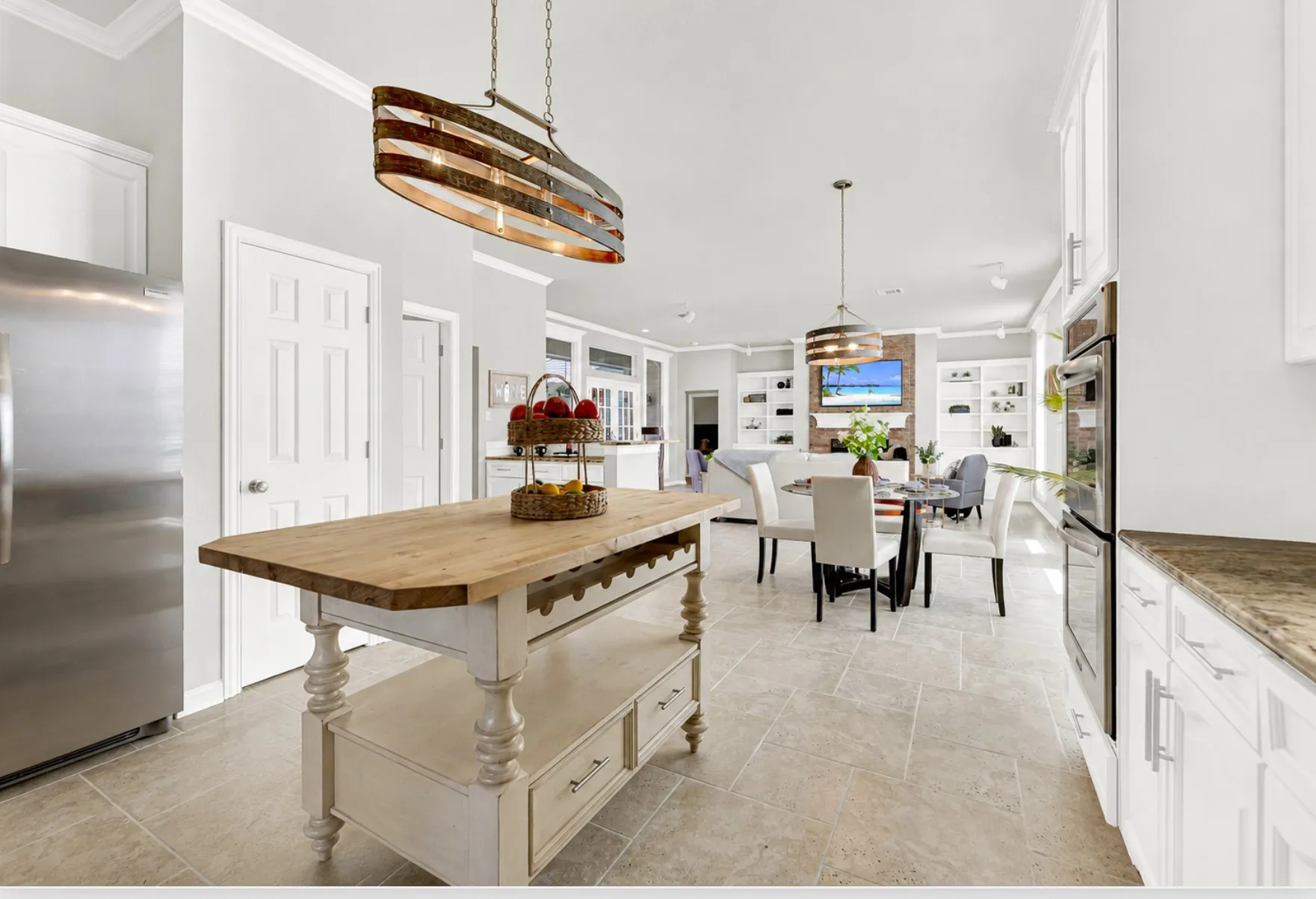 An open sightline flows effortlessly past the central prep station directly into the main living space. You can chat with family lounging by the fireplace while wrapping up evening dinner prep.