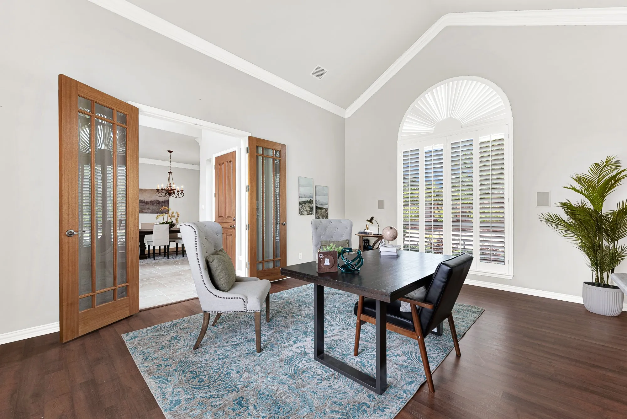 Glass-paned French doors create a seamless connection between the private workspace and nearby formal areas. You can comfortably tackle daily tasks or dive into a good book in total peace.