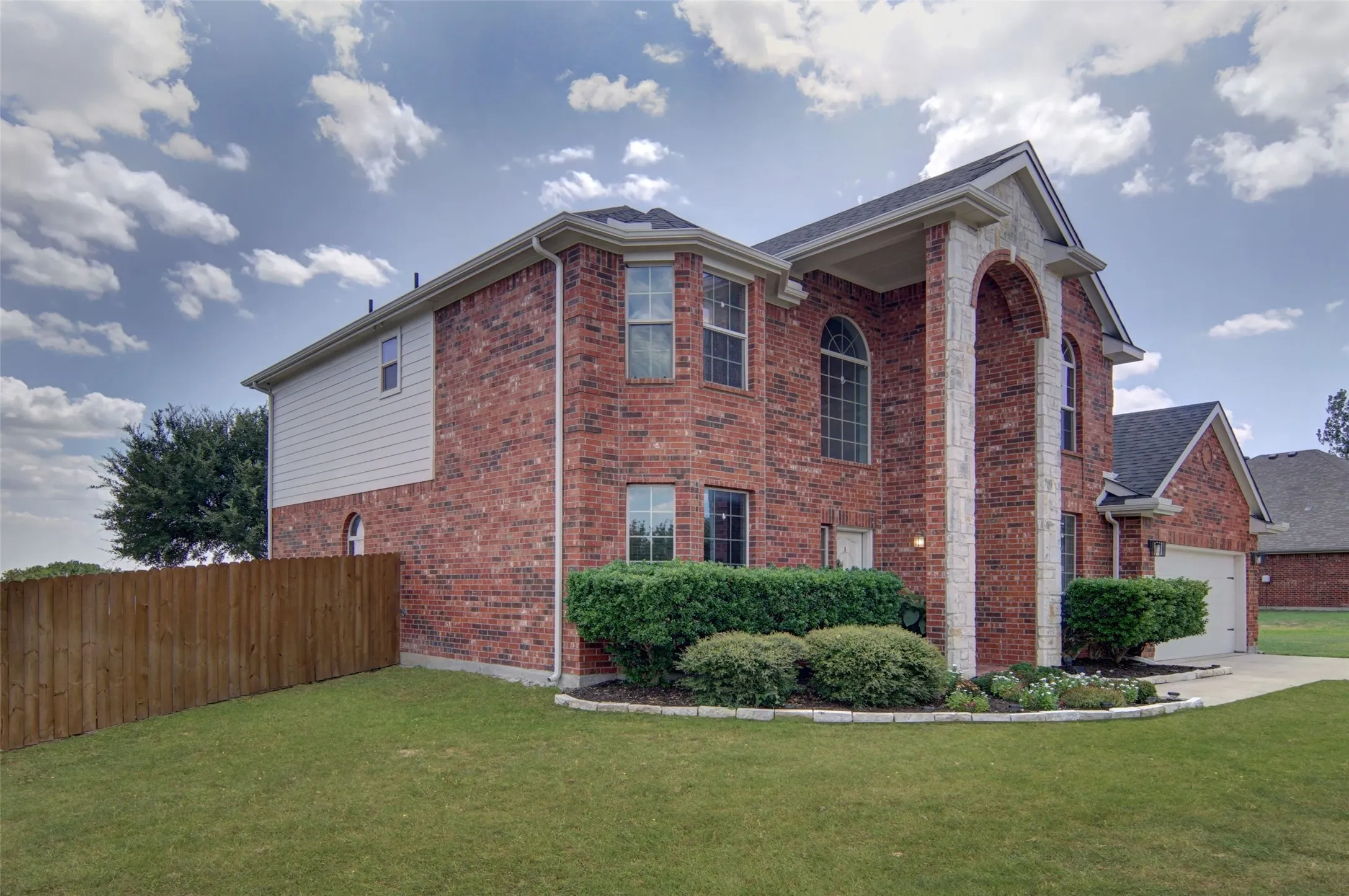 Beautiful landscaping in a cul-de-sac, check out all the windows