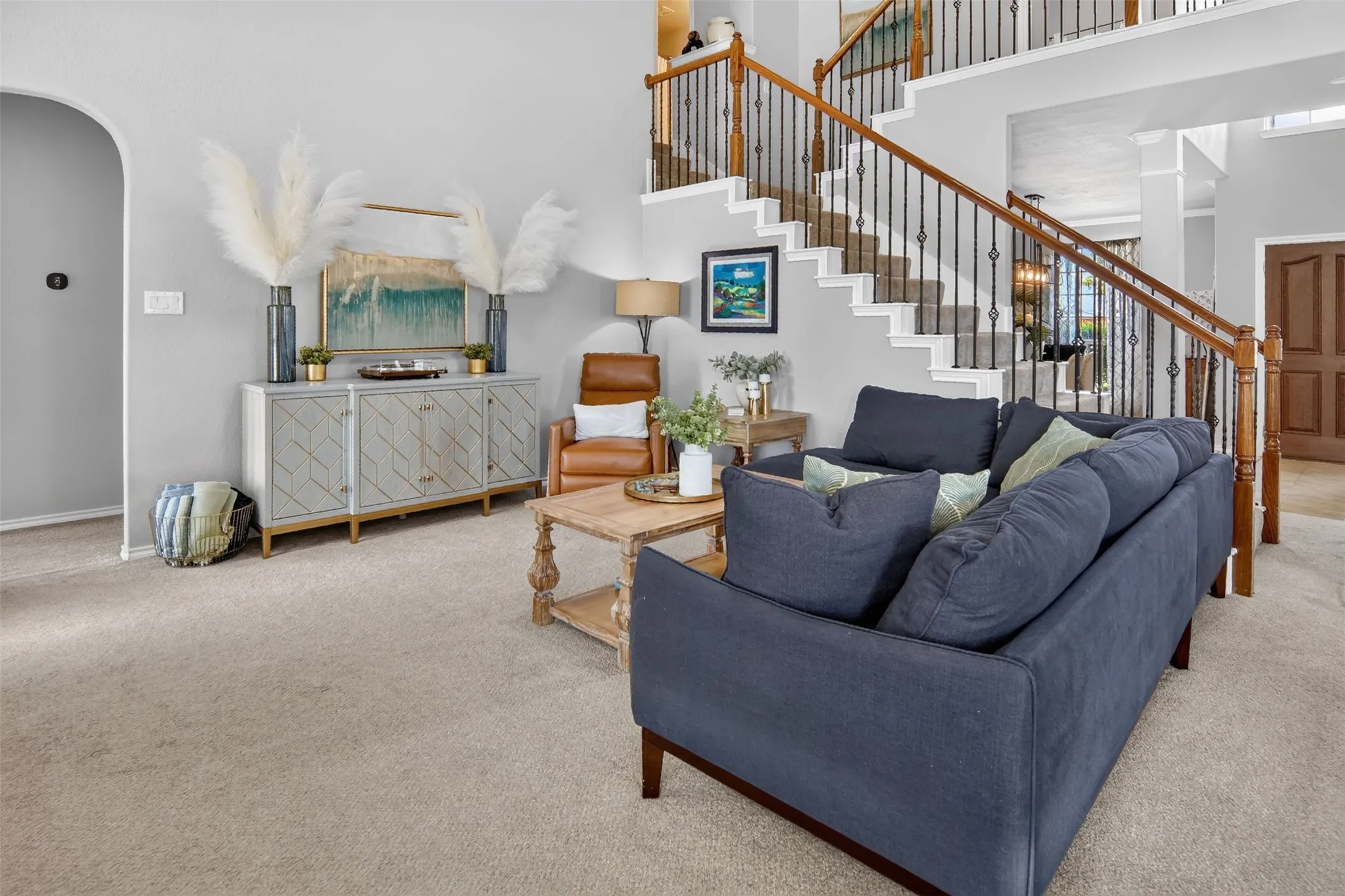 living room with stairs to the second story bedrooms and baths