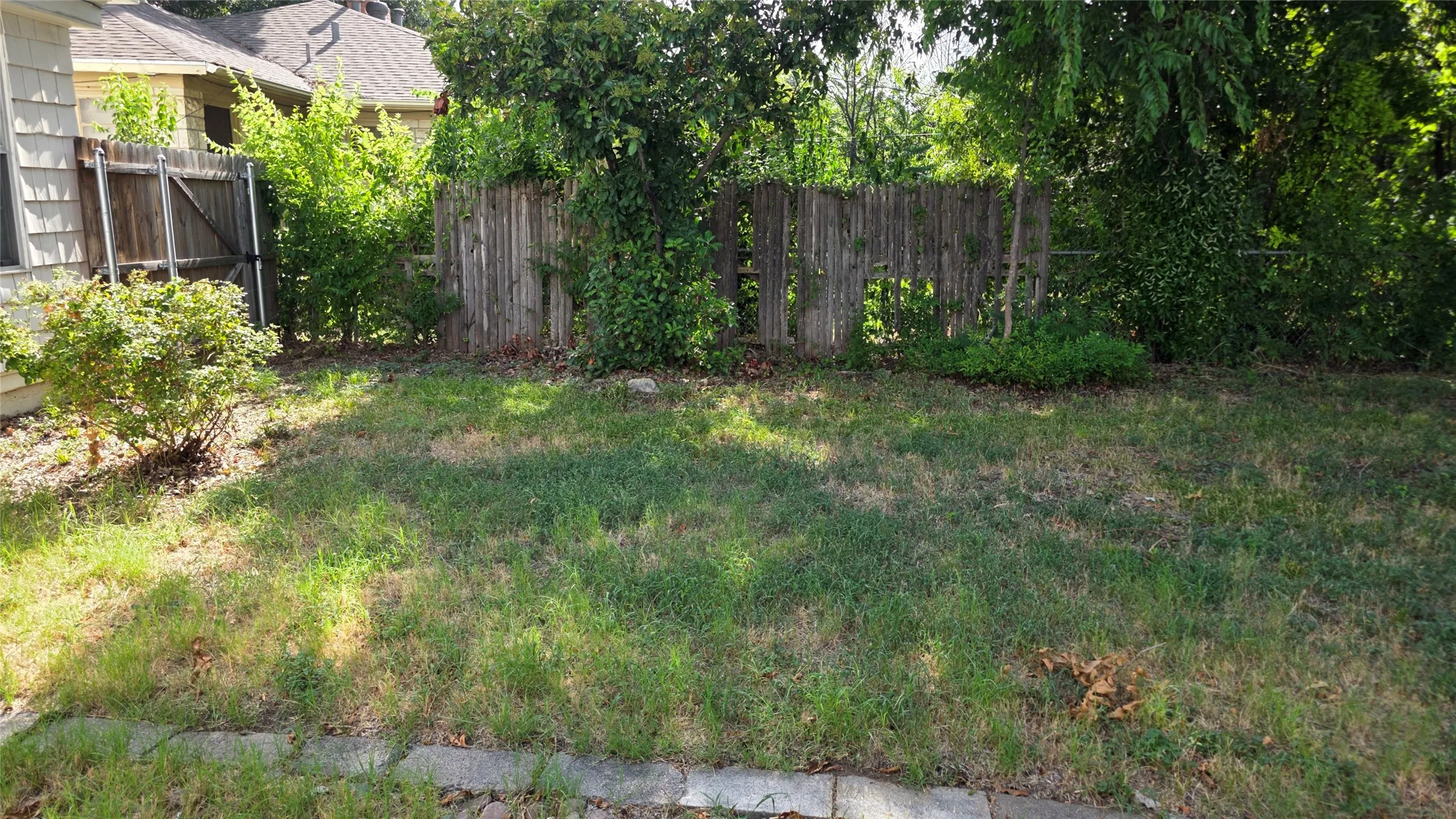 Both downstairs bedrooms have a view to the large, grassy backyard.