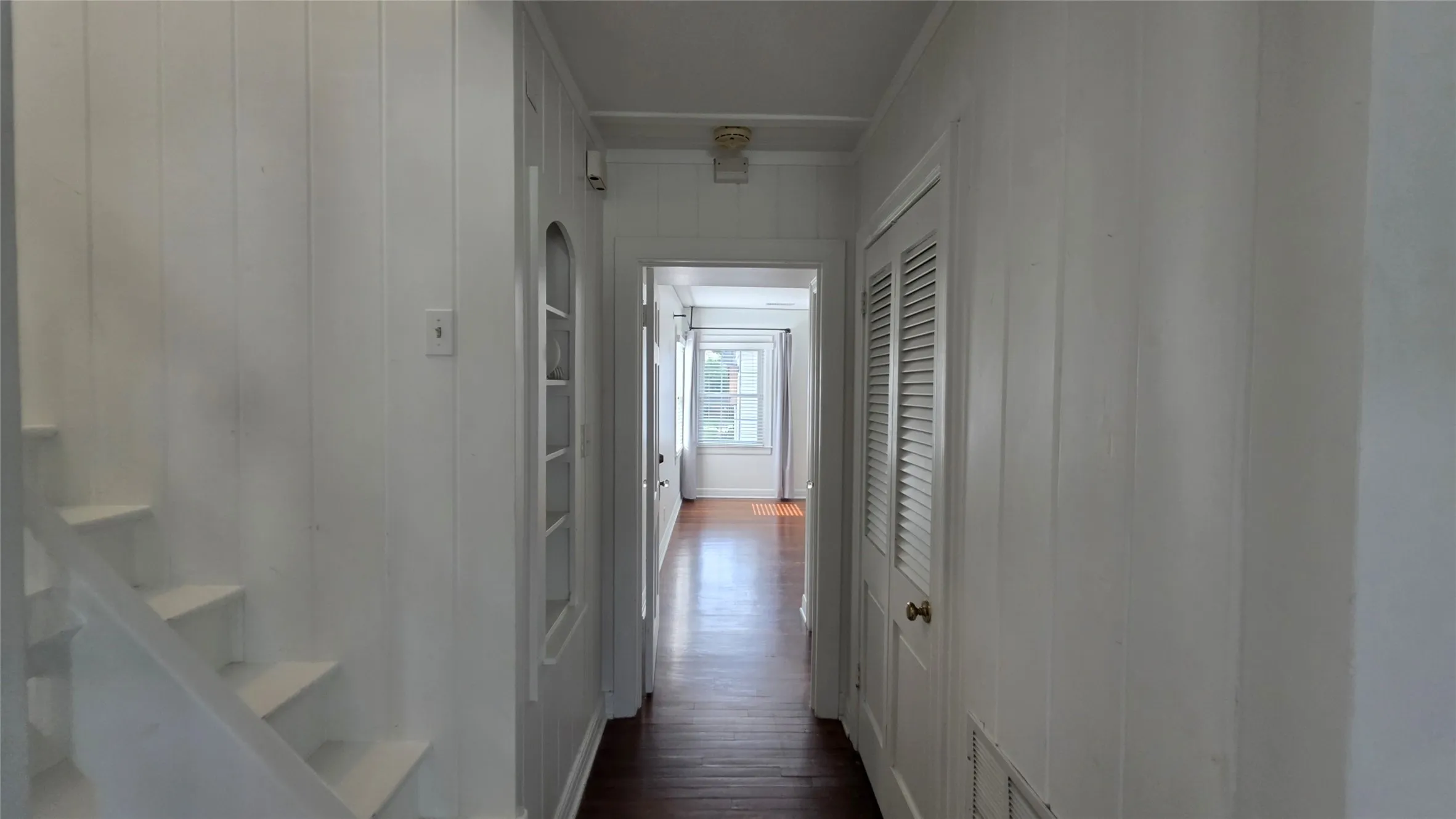 Downstairs hallway to Primary Suite 2 of 2. Archway shelving for your favorite knick-knacks!