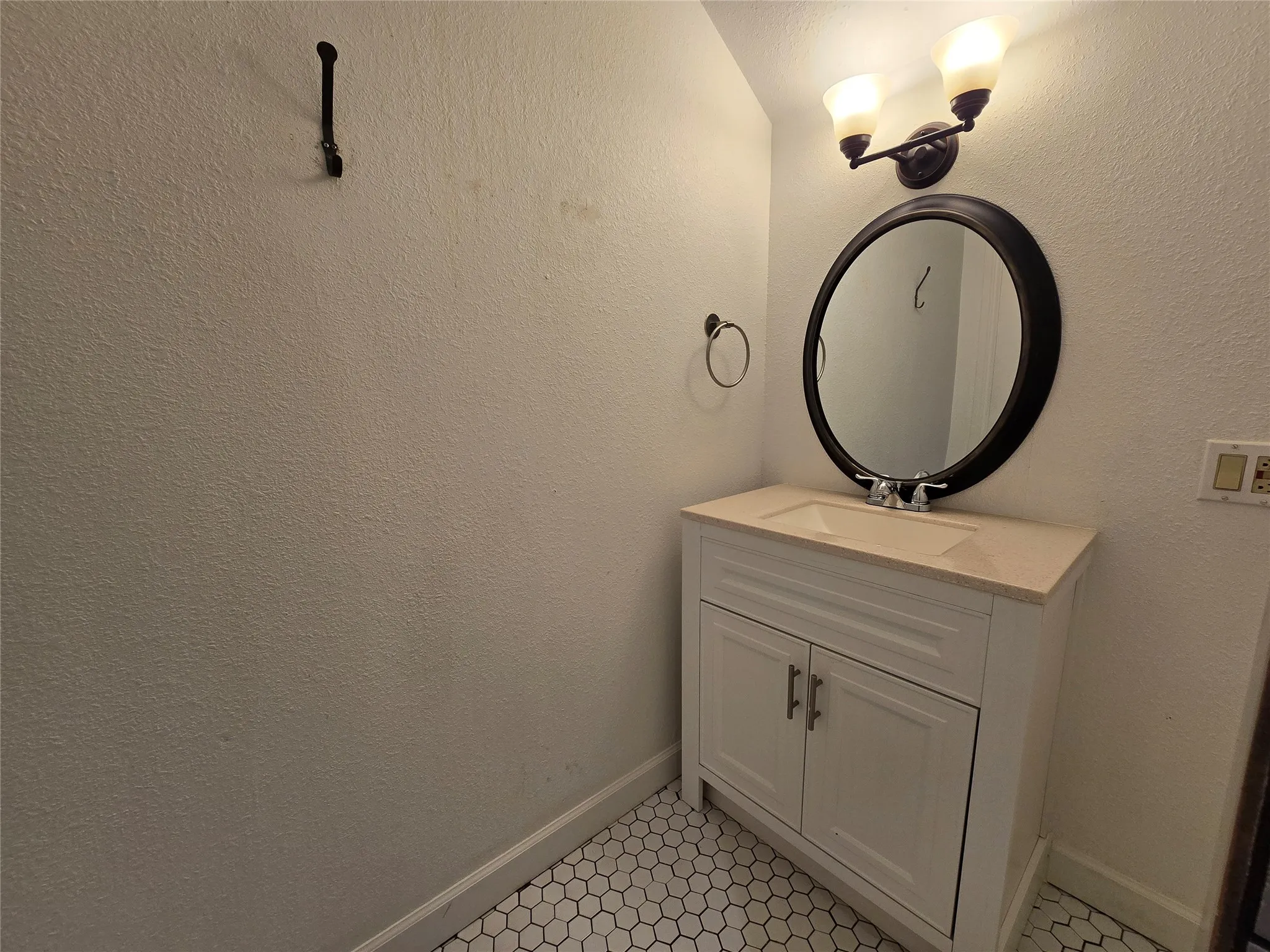 Upstairs, Hall Bathroom with a storage vanity and decorative lighting.