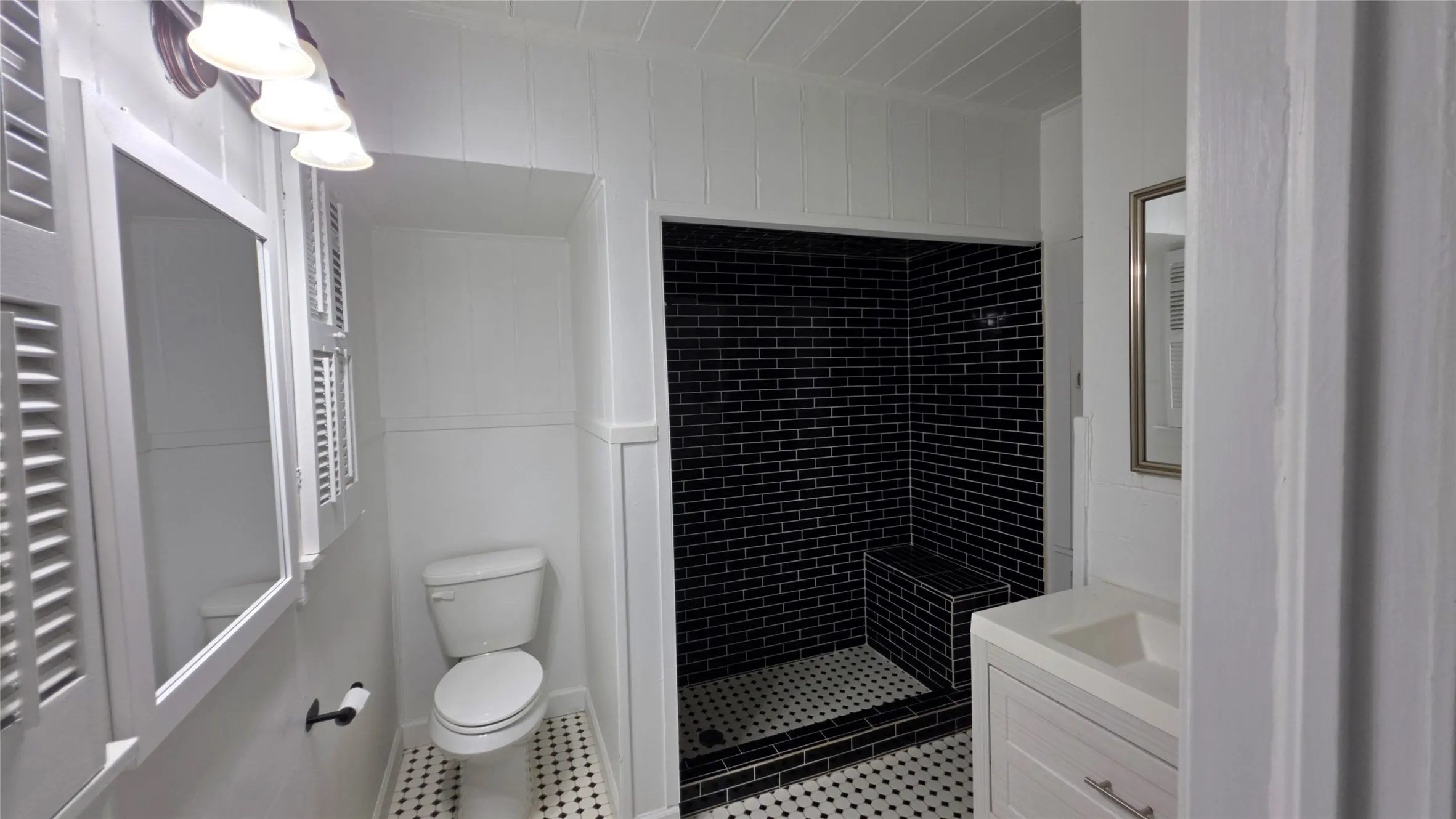 Downstairs, Primary Ensuite Bath 2 of 2. A storage vanity, plus additional built-in toiletry storage near the shower!