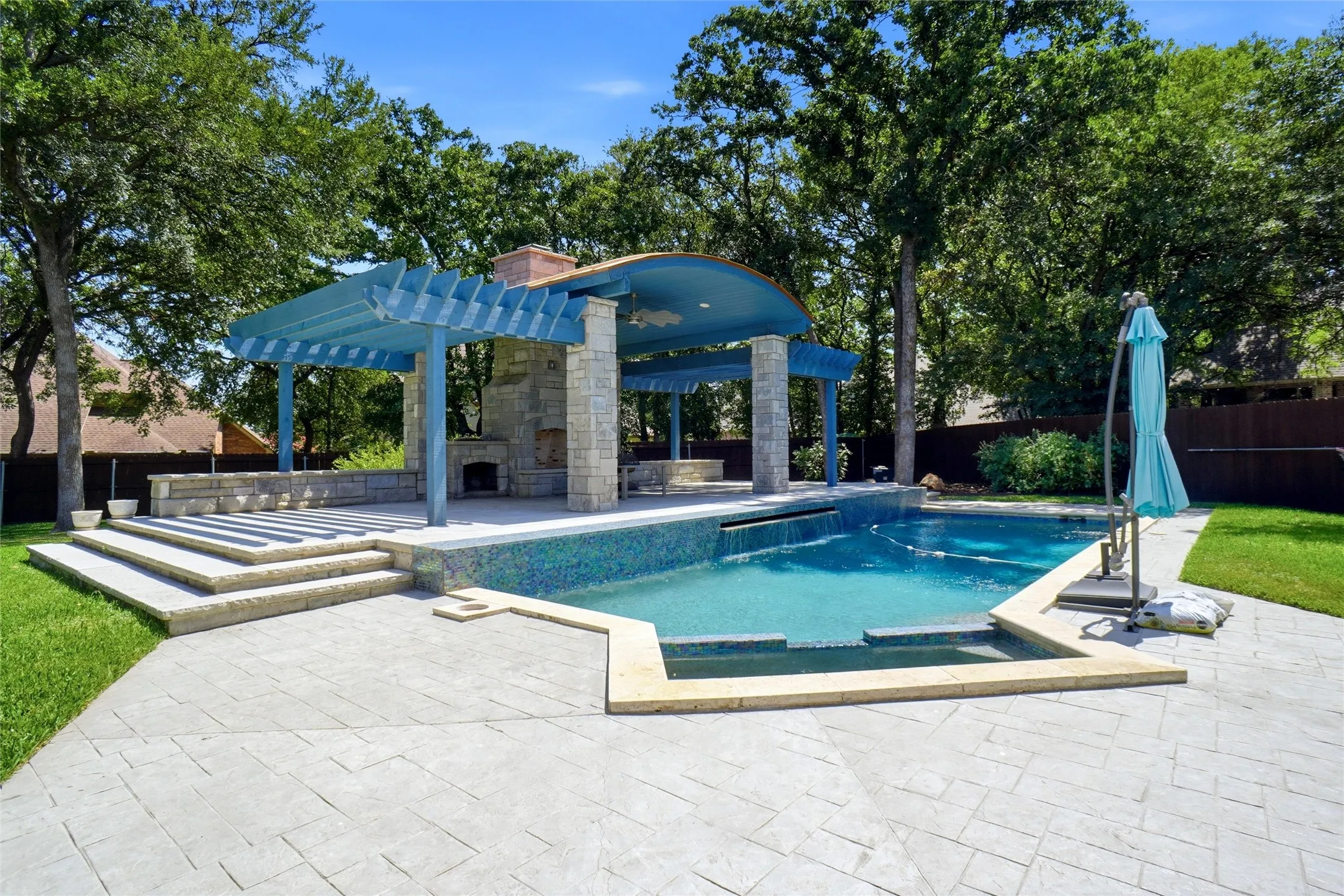 Entertaining space perfect for hosting, complete with a refreshing pool.