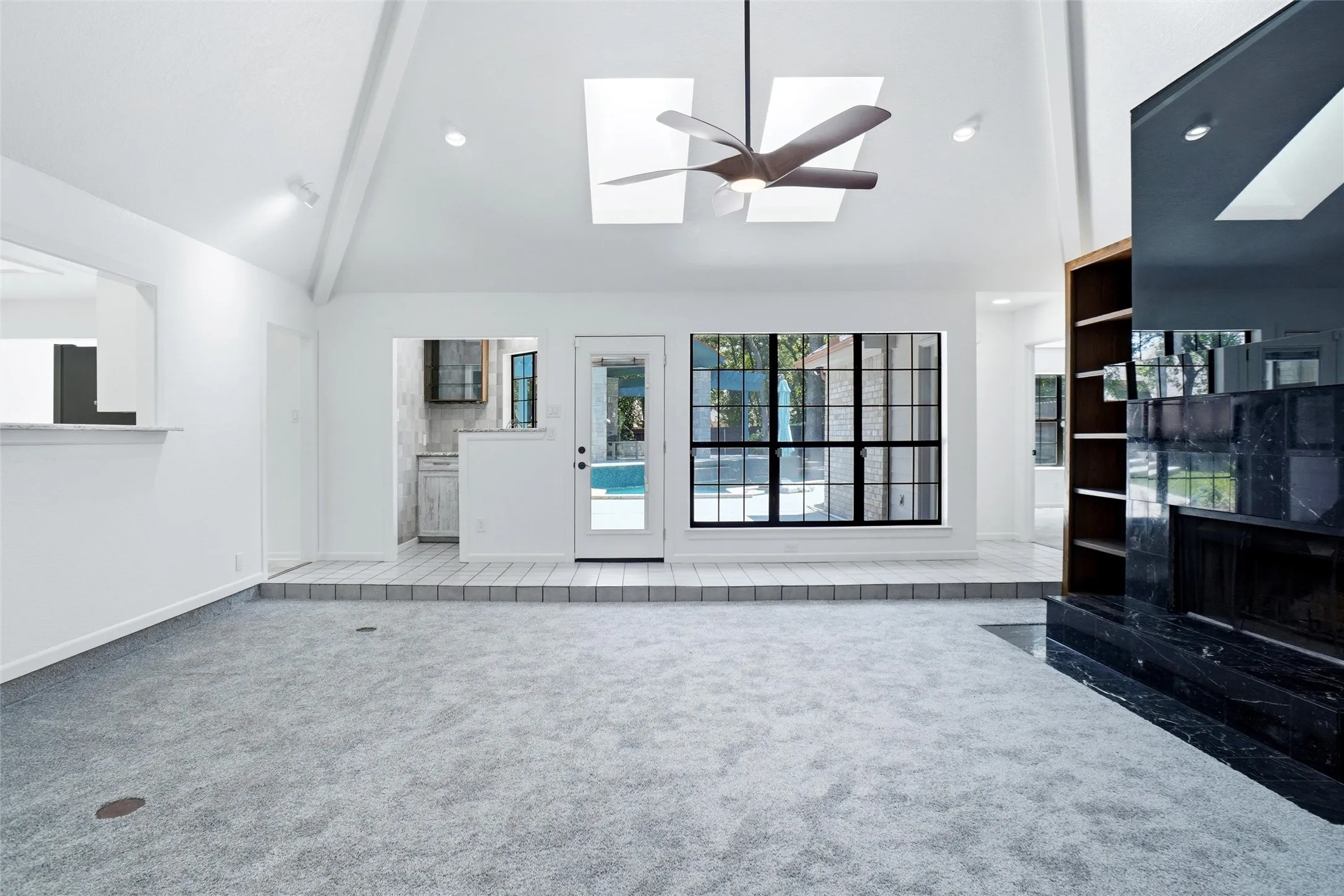 Spacious Living Room......sky lights in vaulted ceiling and great views of the back yard, pool and covered pavillion!
