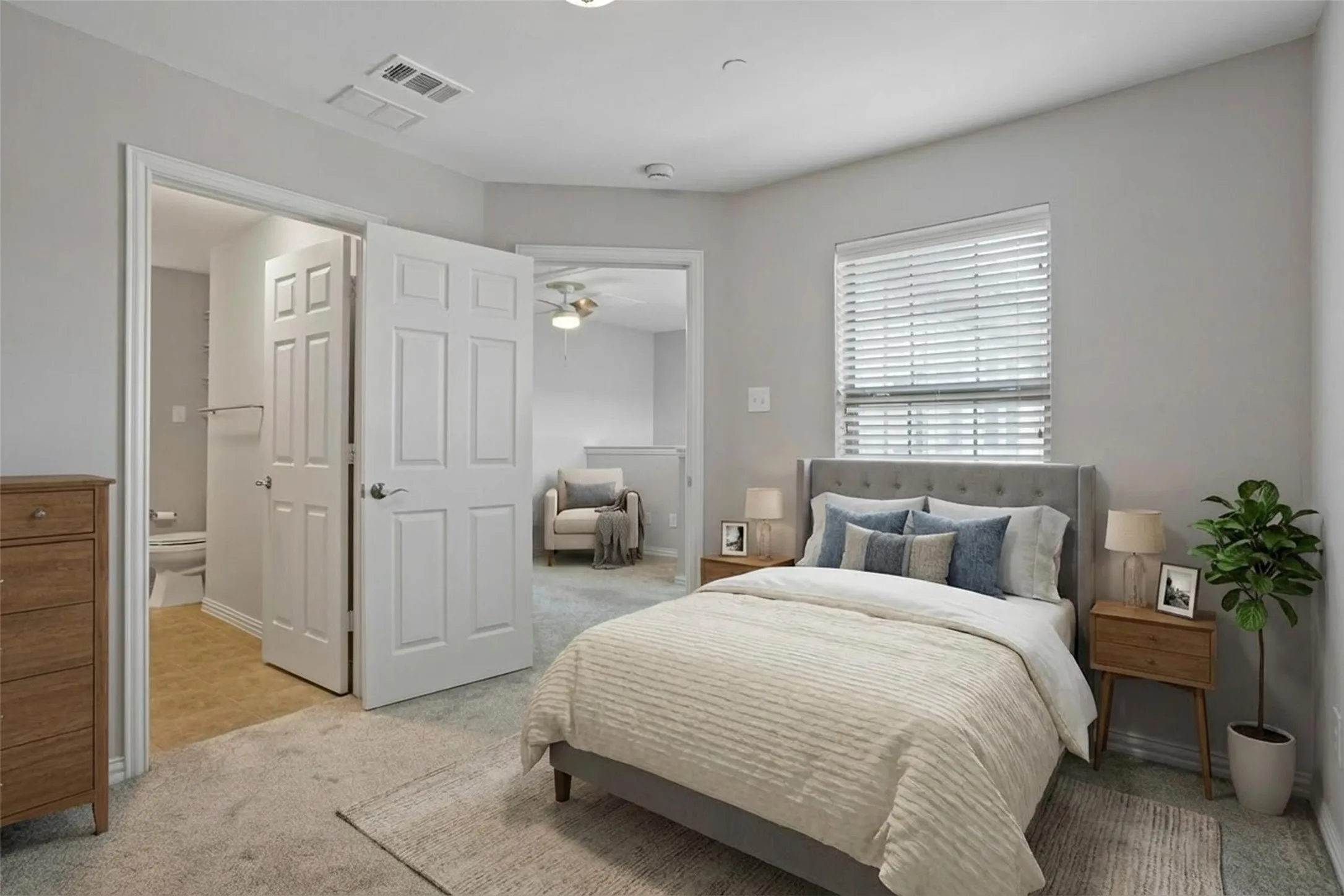 Plush carpeted flooring, window with horizontal blinds, built-in overhead lighting, and a paneled interior door