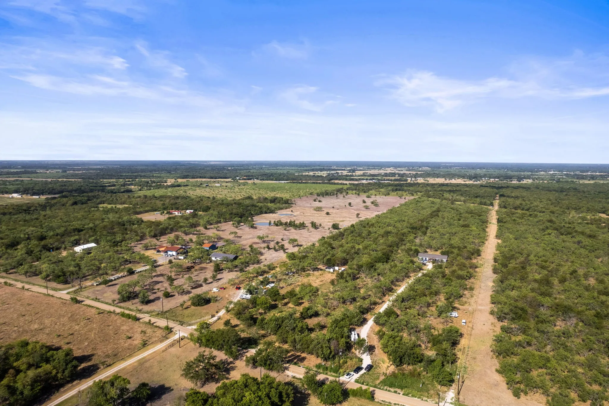 Extensive acreage with multiple structures and a long, unpaved access road