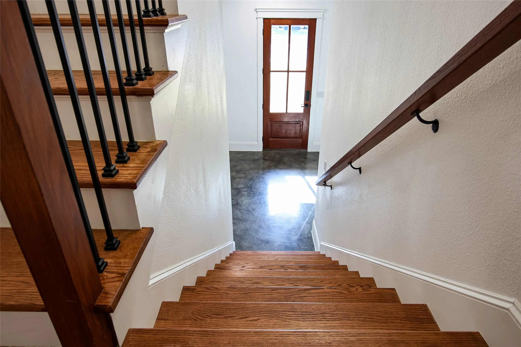 Hardwood stairs with painted risers and decorative newel posts