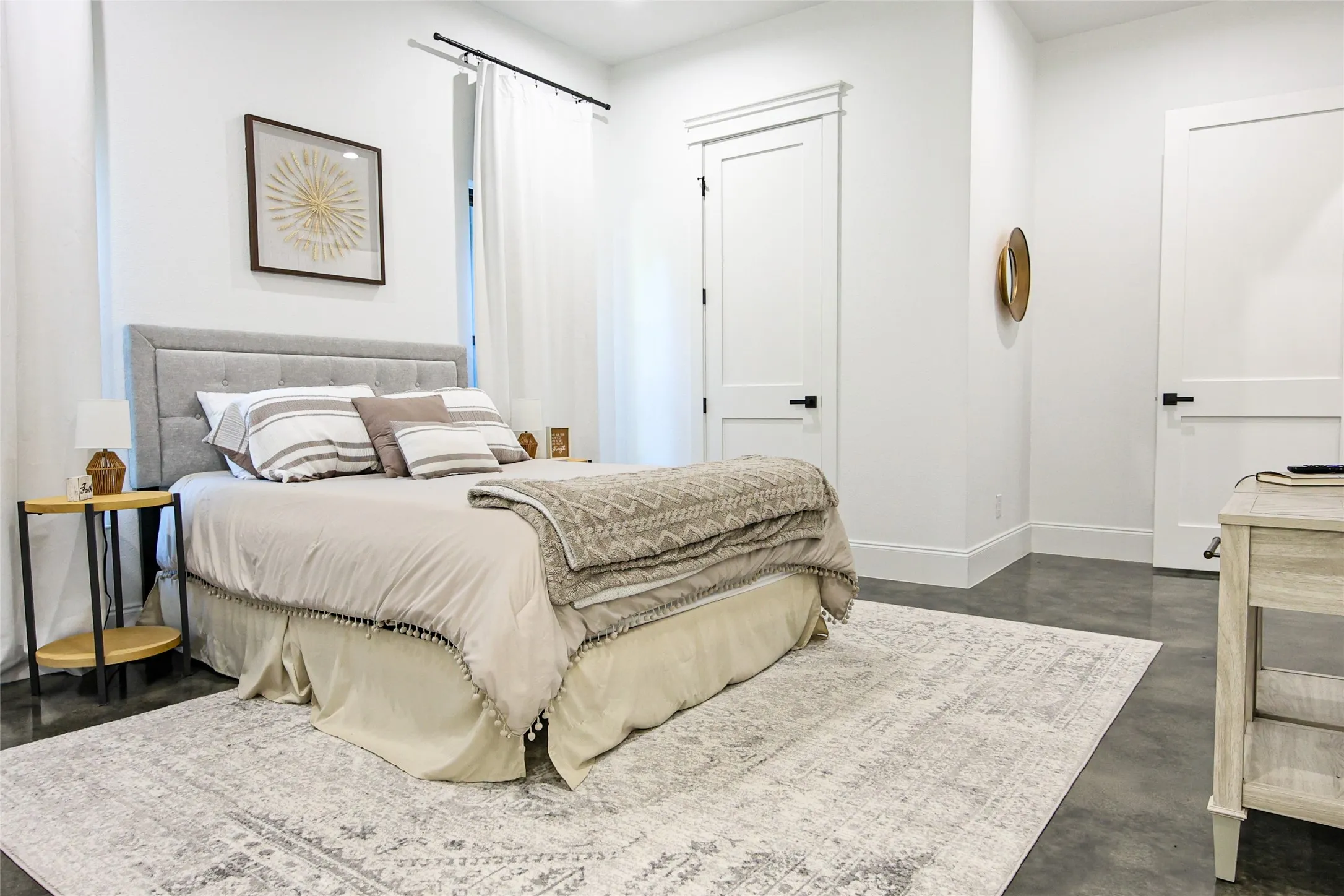 Light-filled room featuring polished concrete flooring