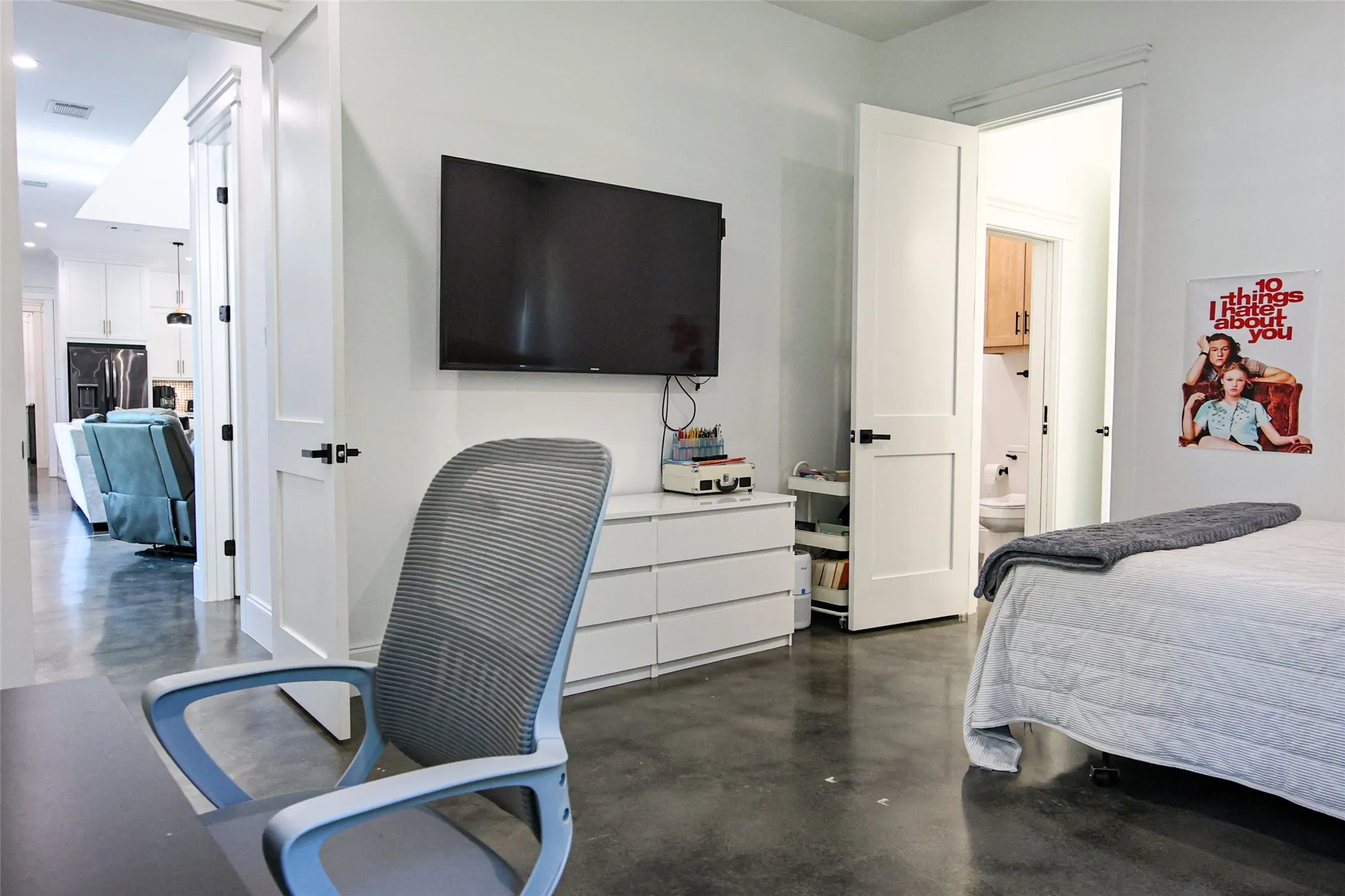 Polished concrete flooring throughout, with white interior doors and black hardware