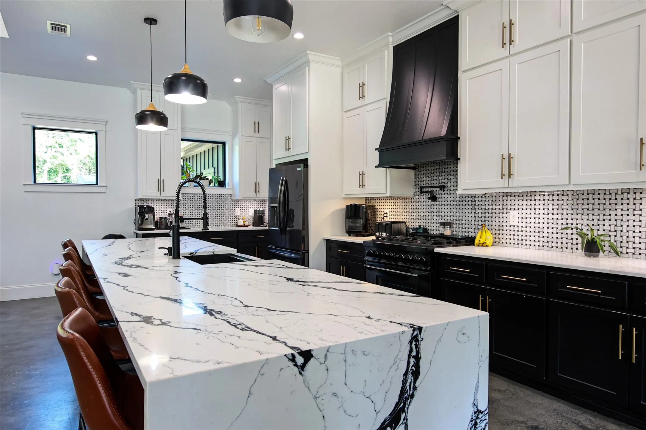 Expansive kitchen island with a waterfall edge and integrated sink