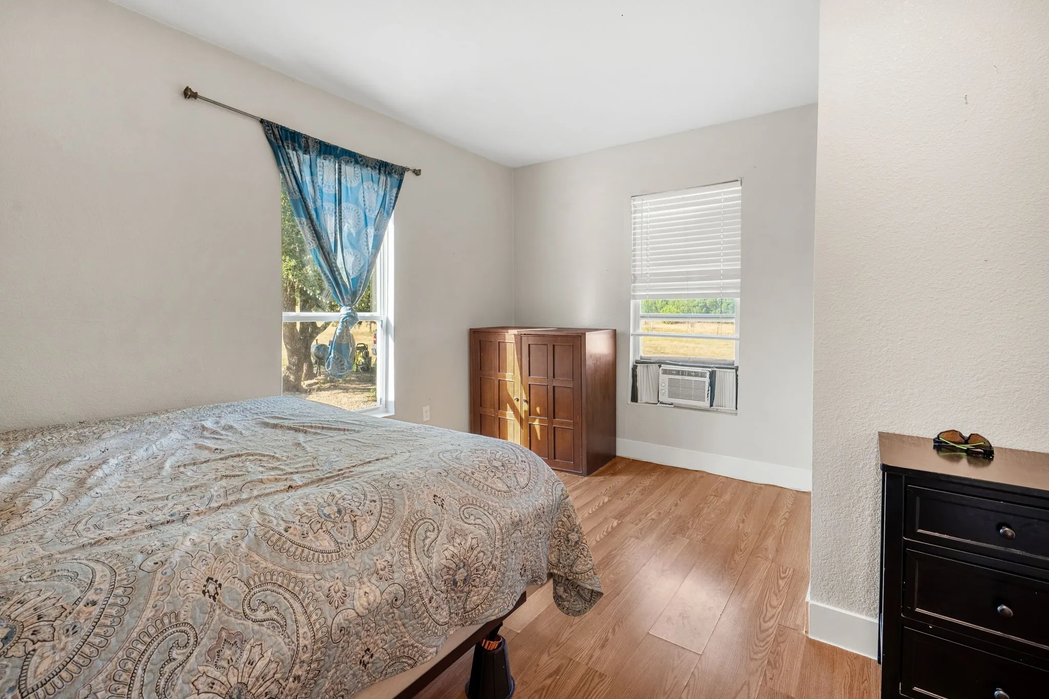 Light-toned walls complement the wood-finish flooring
