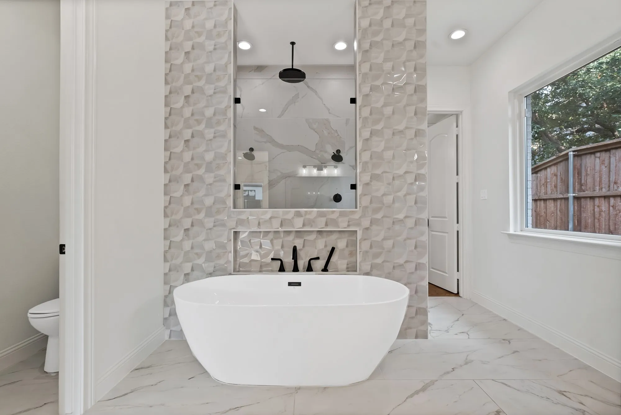 Freestanding soaking tub with matte black fixtures, textured geometric wall tile, walk-in shower with large format tile, and white framed window