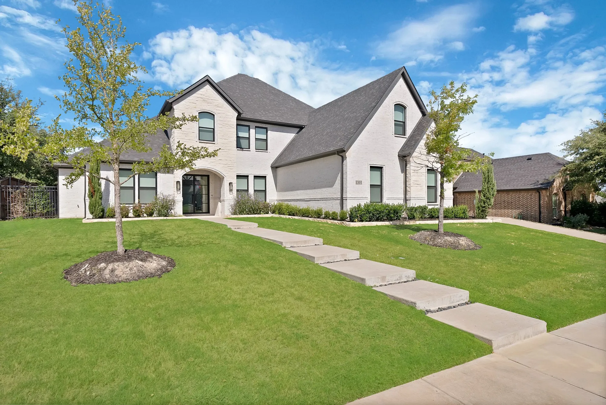 White brick exterior with dark trim windows