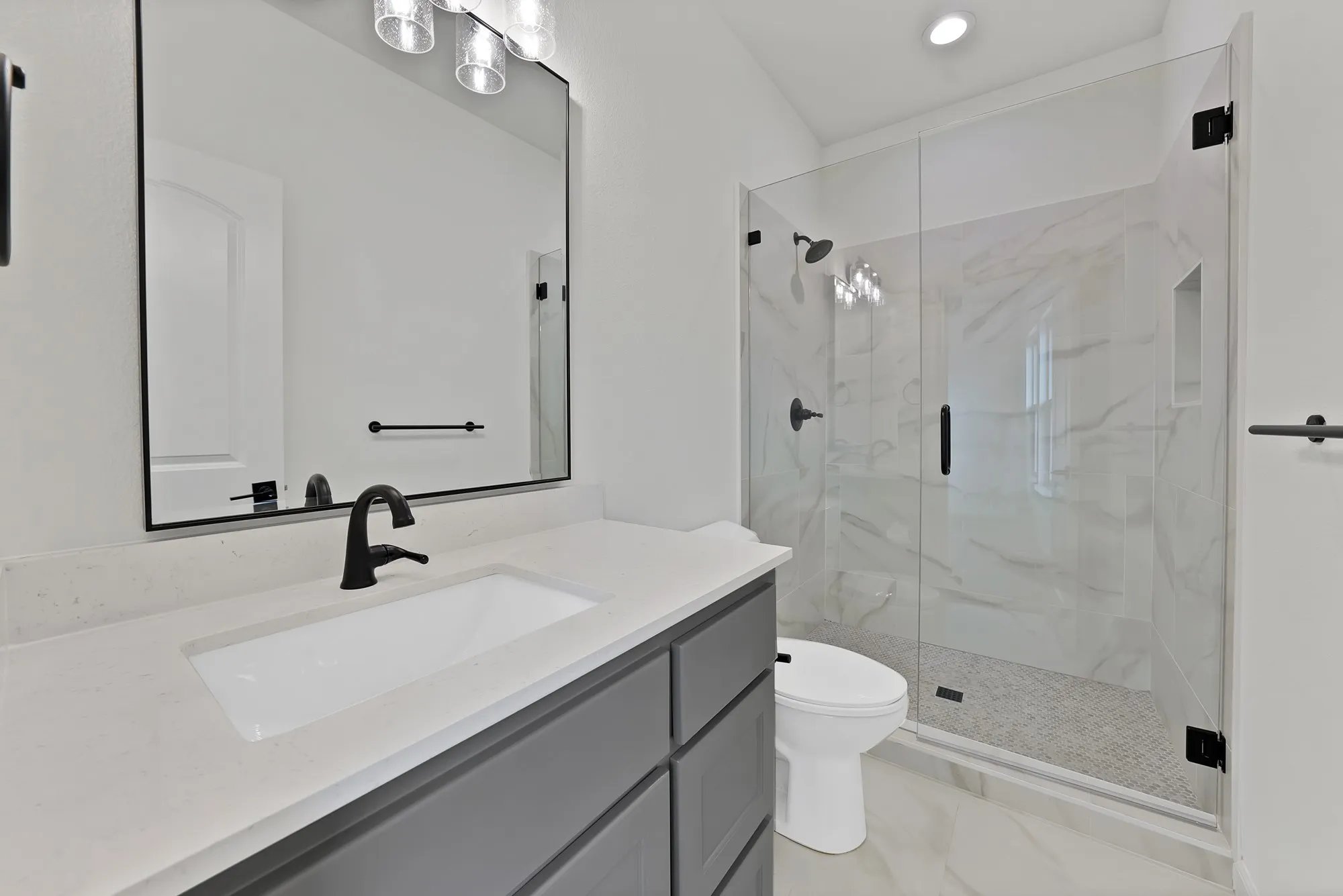 Integrated vanity with a single basin sink and matte black faucet