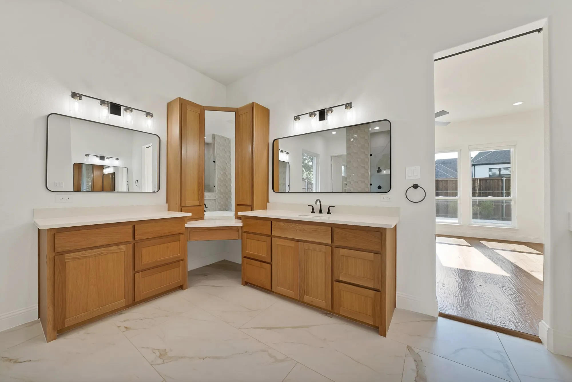 Dual wood-finish vanities with light countertops, recessed lighting, and rectangular mirrors
