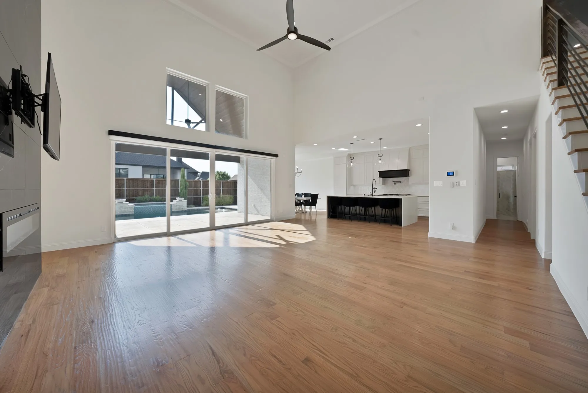 Vaulted ceilings, wood-finish flooring, and expansive sliding glass doors