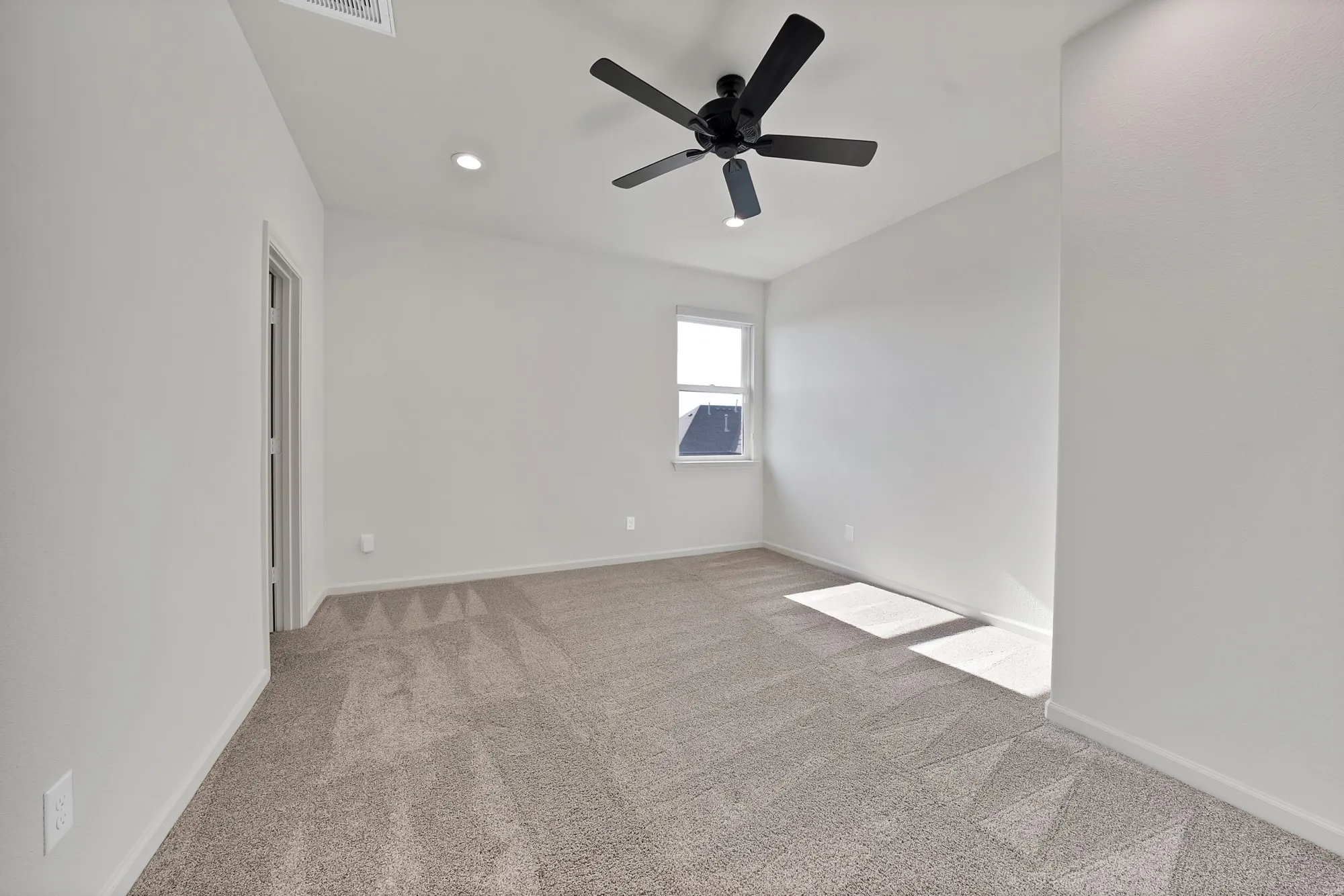 Vaulted ceiling with a ceiling fan, recessed lighting, carpet flooring, and a window