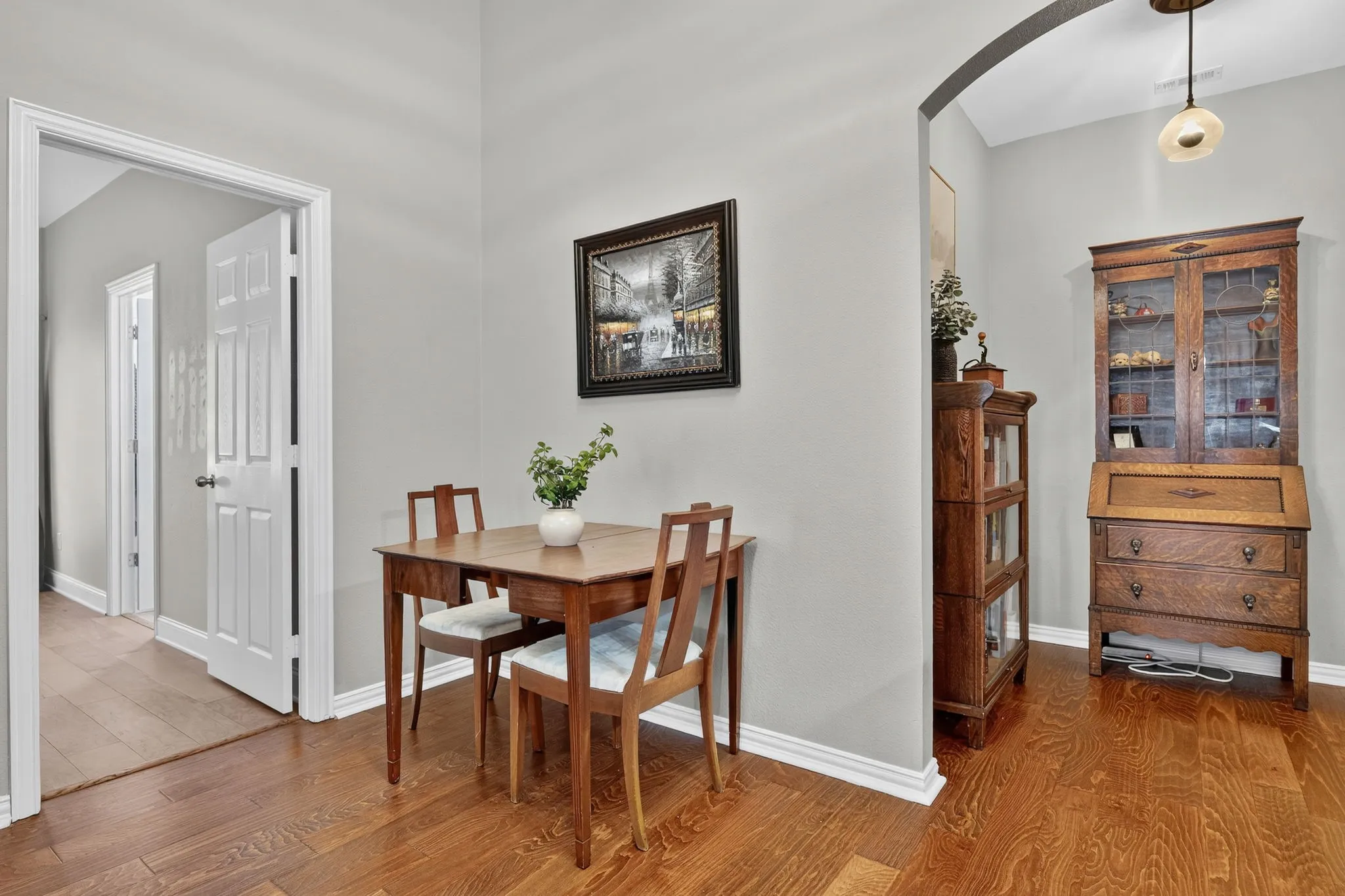 Wood-finish flooring throughout, light gray wall paint, and white trim