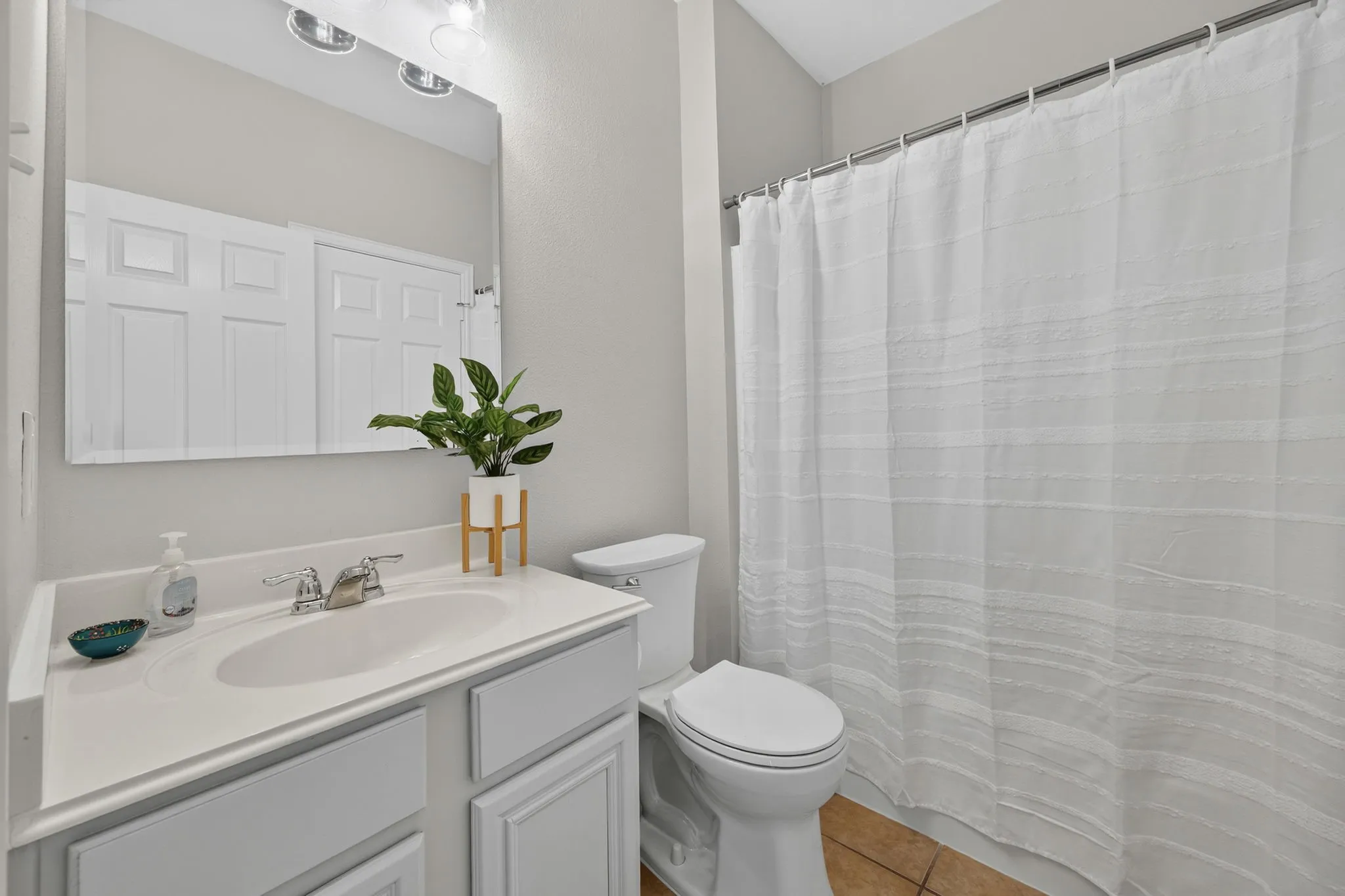 White vanity with an integrated sink and chrome faucet
