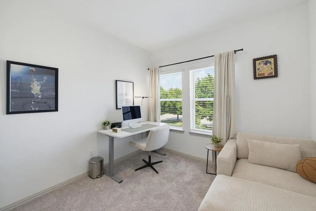 Bright room with neutral wall tones and carpeted flooring