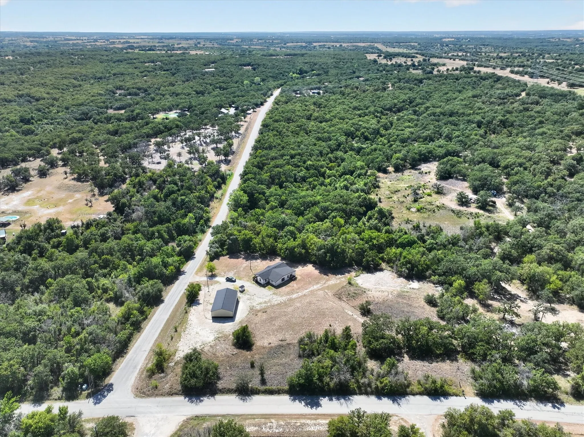 Aerial perspective showcasing the property with a visible structure and an additional outbuilding
