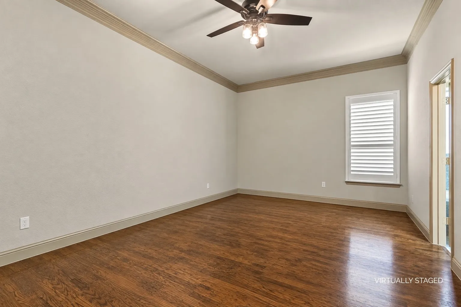 Primary bedroom with ceiling fan and ensuite bathroom