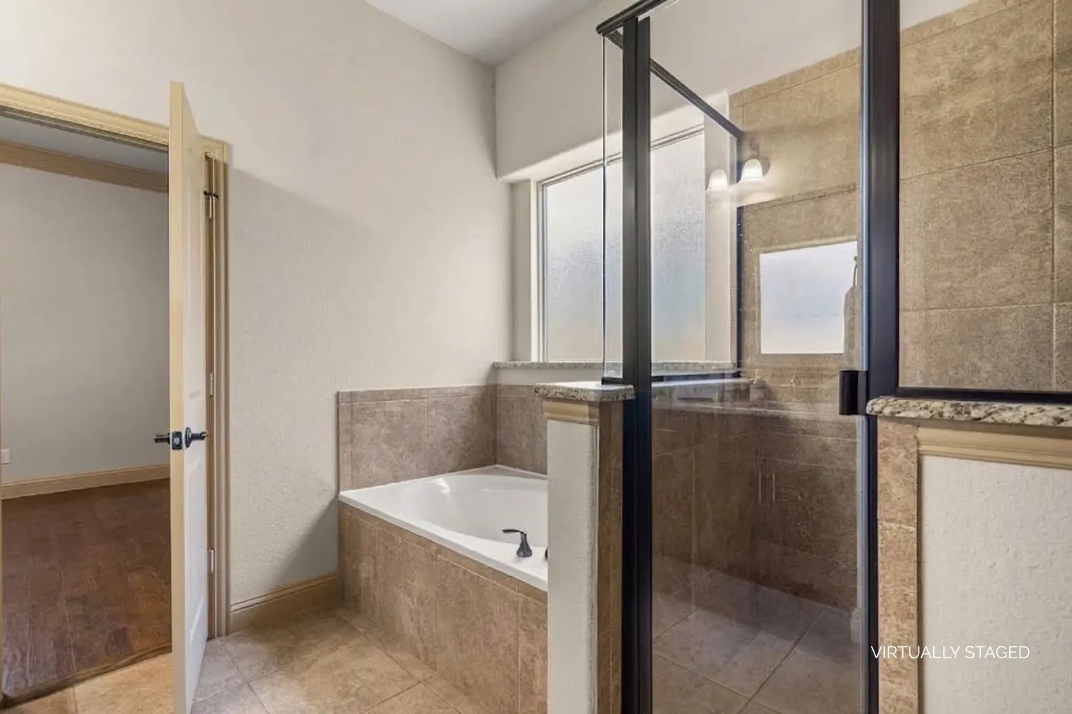 Primary bathroom features both tub and walk-in shower