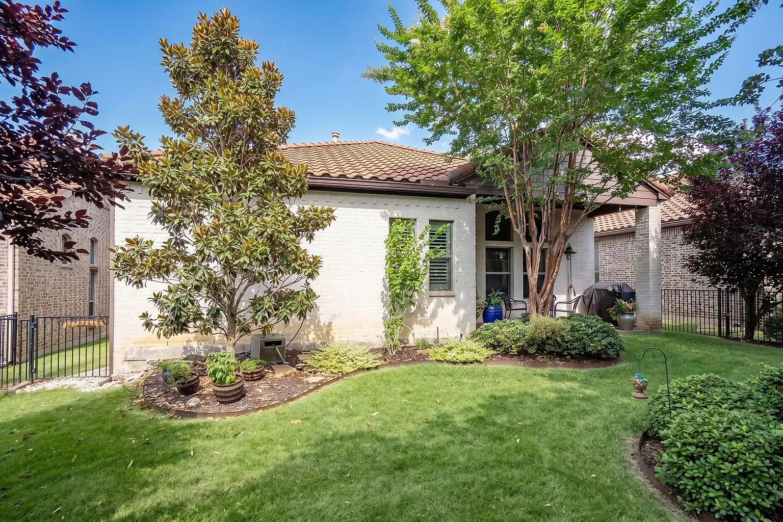 Beautiful private yard with gorgeous array of landscaping throughout